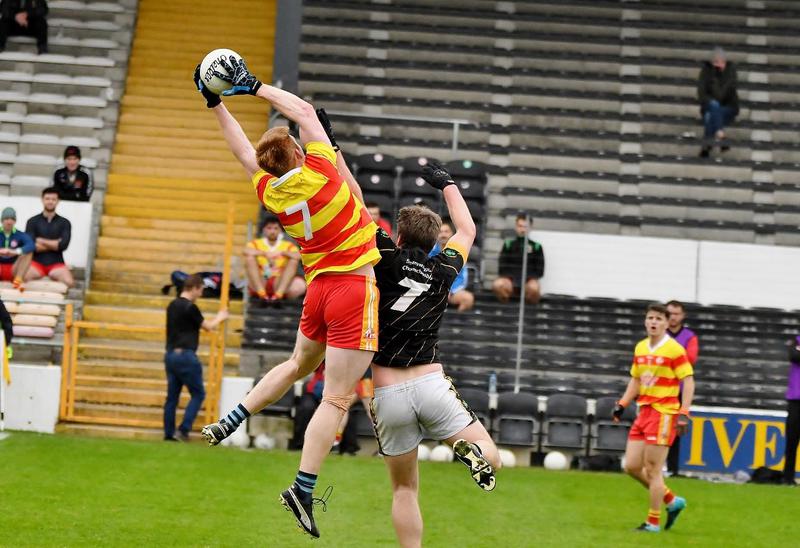 Players from the Barcelona Gaels (left) and Conahy Shamrocks (right) contend for a high ball in their championship match