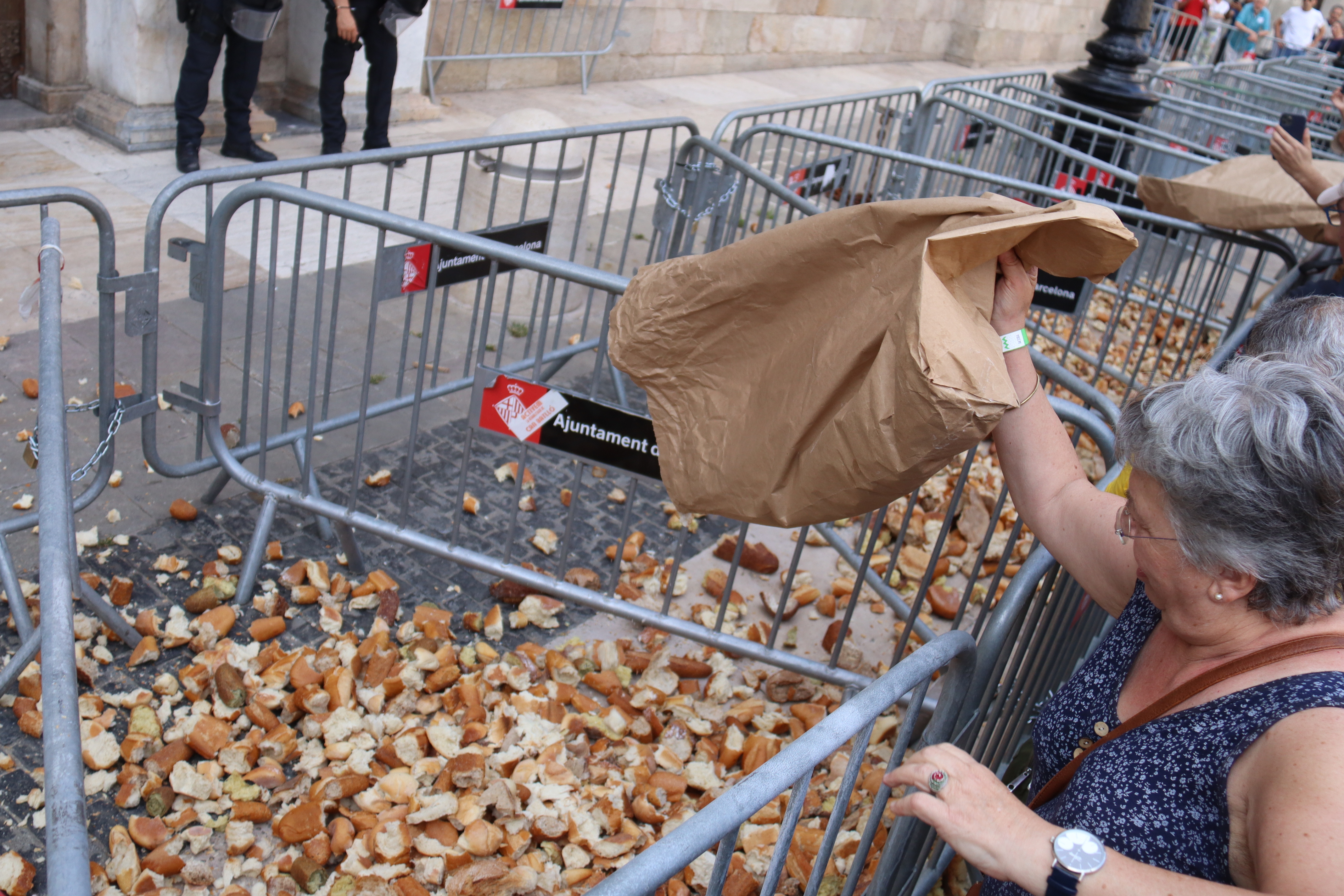 Protesters throwing dry bread crusts at the doors of the Catalan government headquarters.