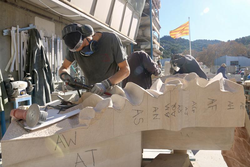 Stonemasons at Granits Barbany work on pieces of the Jesus Christ tower of the Sagrada Família