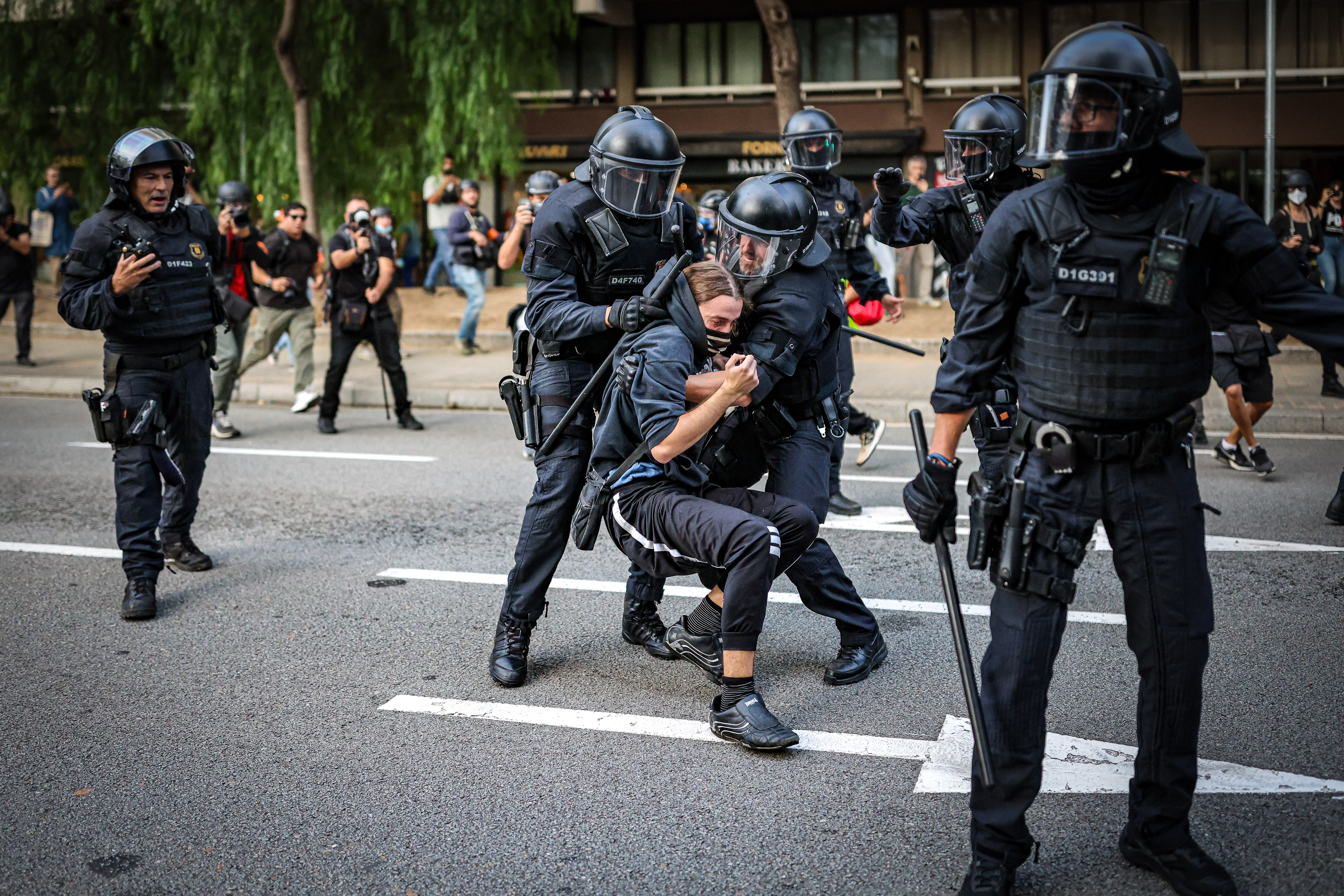 Police officers arrest a person during a pro-Palestine demonstration in Barcelona