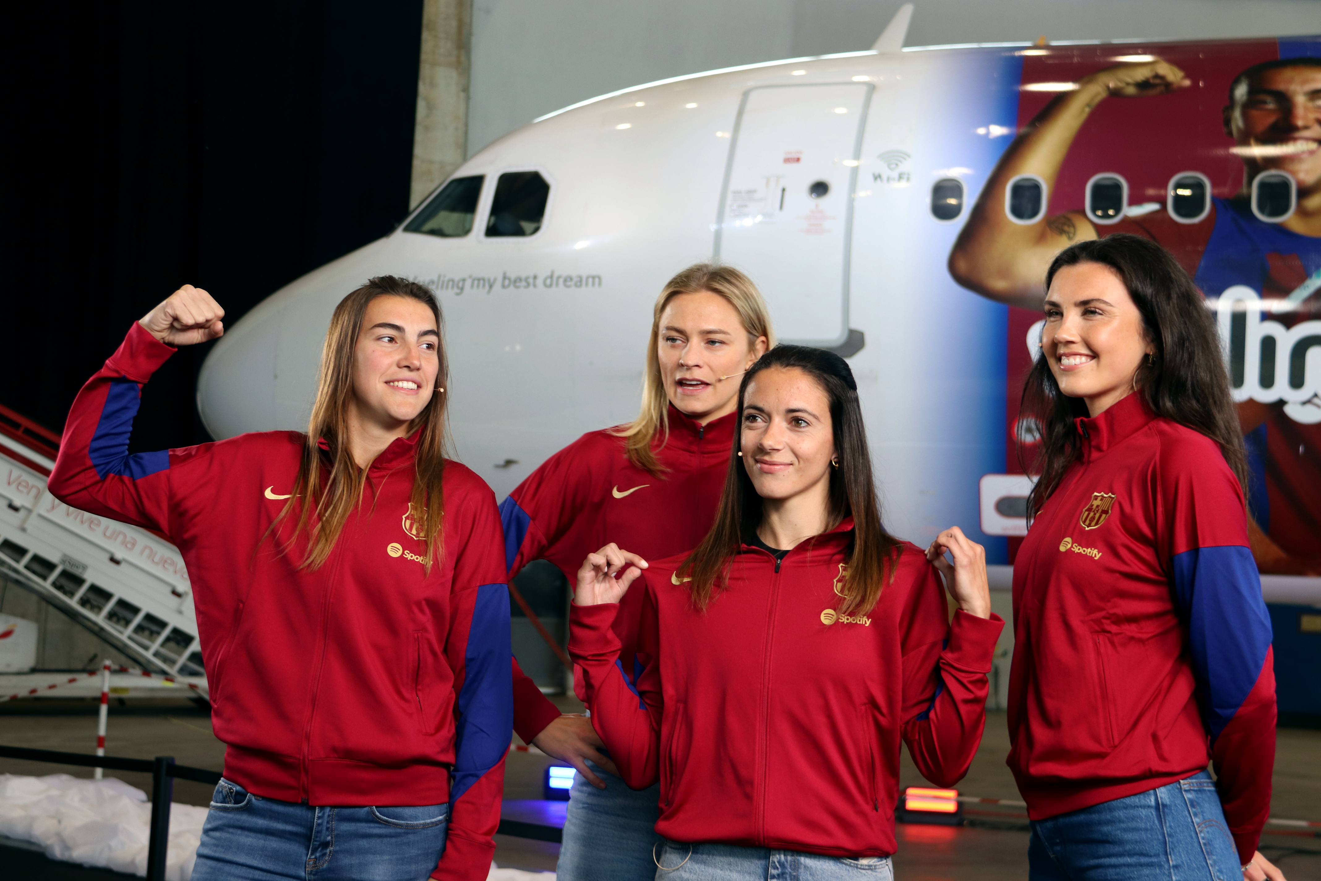 FC Barcelona women's team players Aitana Bonmatí, Fridolina Rolfö, Ingrid Engen, and Patri Guijarro in front of an airplane by Vueling branded with their faces on April 25, 2024