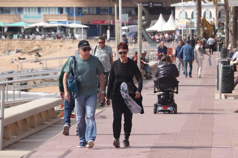 Tourists walking on the seafront promenade in Lloret de Mar