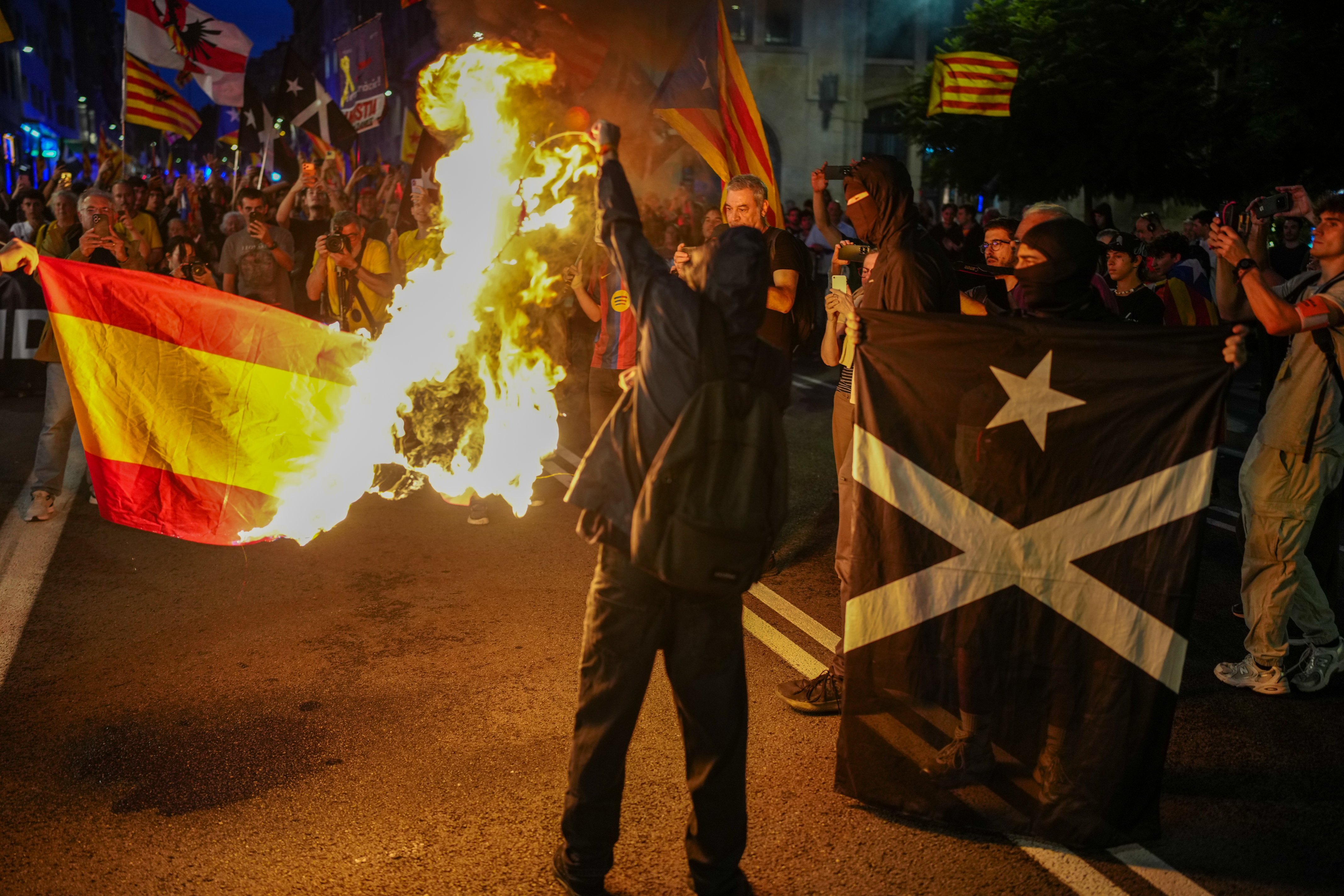 A Spanish flag is set alight