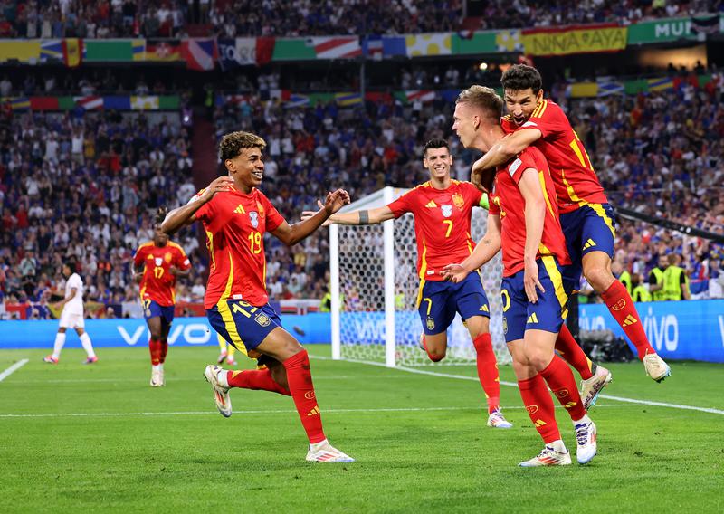 Dani Olmo celebrates with Lamine Yamal and Jesus Navas after Jules Kounde of France concedes an own goal, resulting in Spain's second goal, during the UEFA EURO 2024 Semi-Final match between Spain and France on July 09, 2024, in Munich, Germany