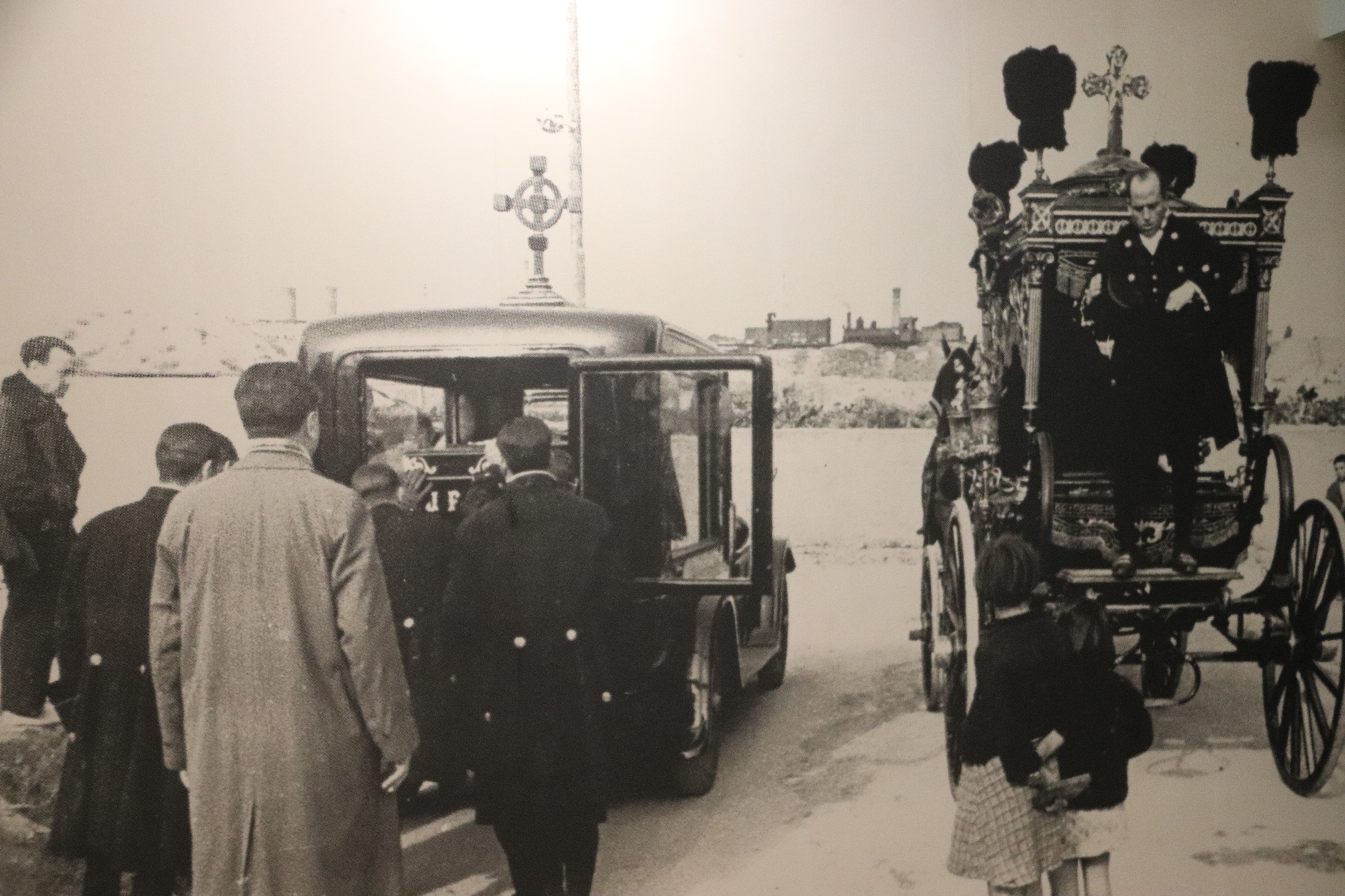 A picture showing how funerals changed from using carriages to motorized cars