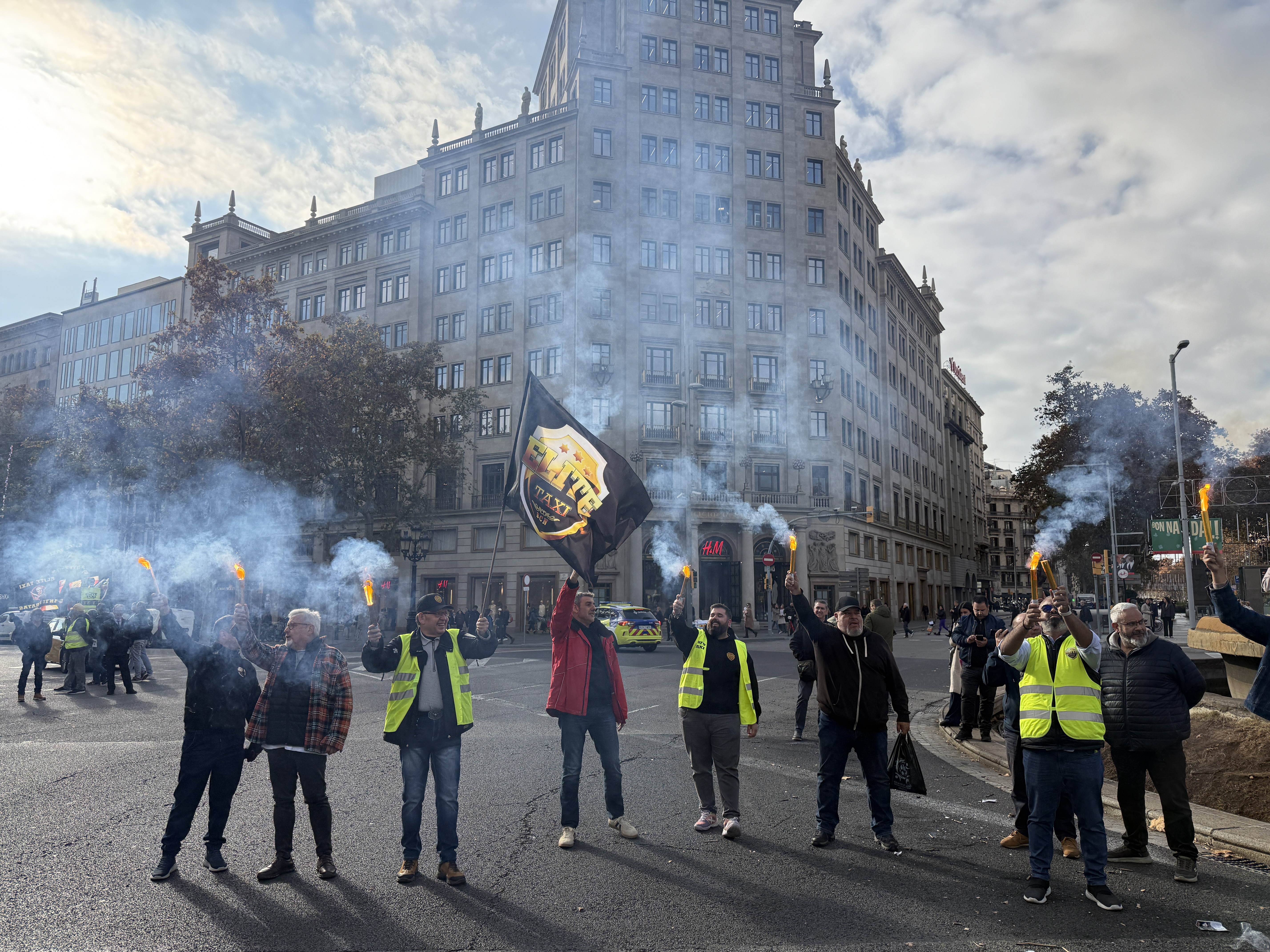 Protesters light flares during a taxi strike in Barcelona on December 9, 2025