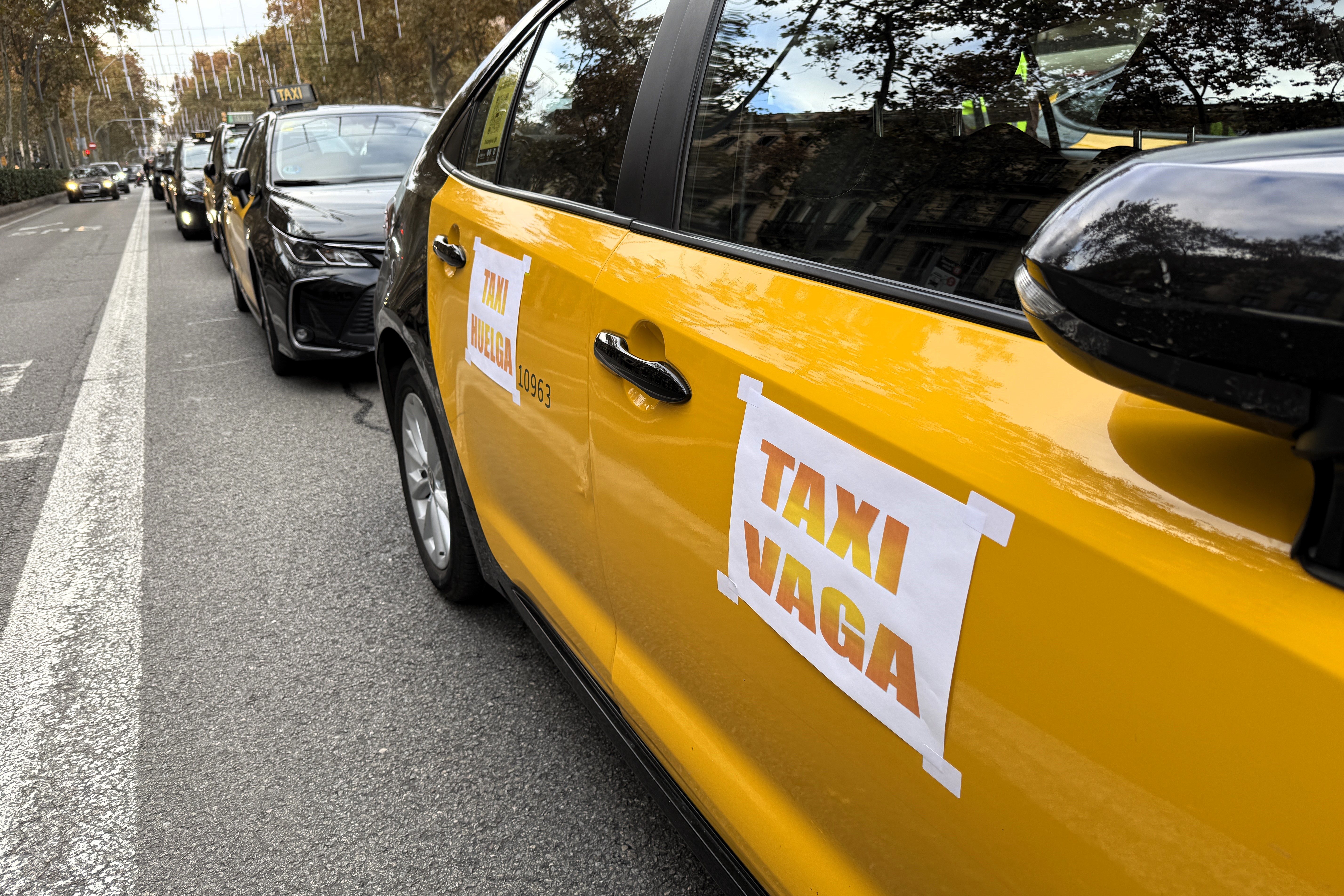 A taxi with a poster reading 'Taxis on strike' during a strike on December 9, 2025