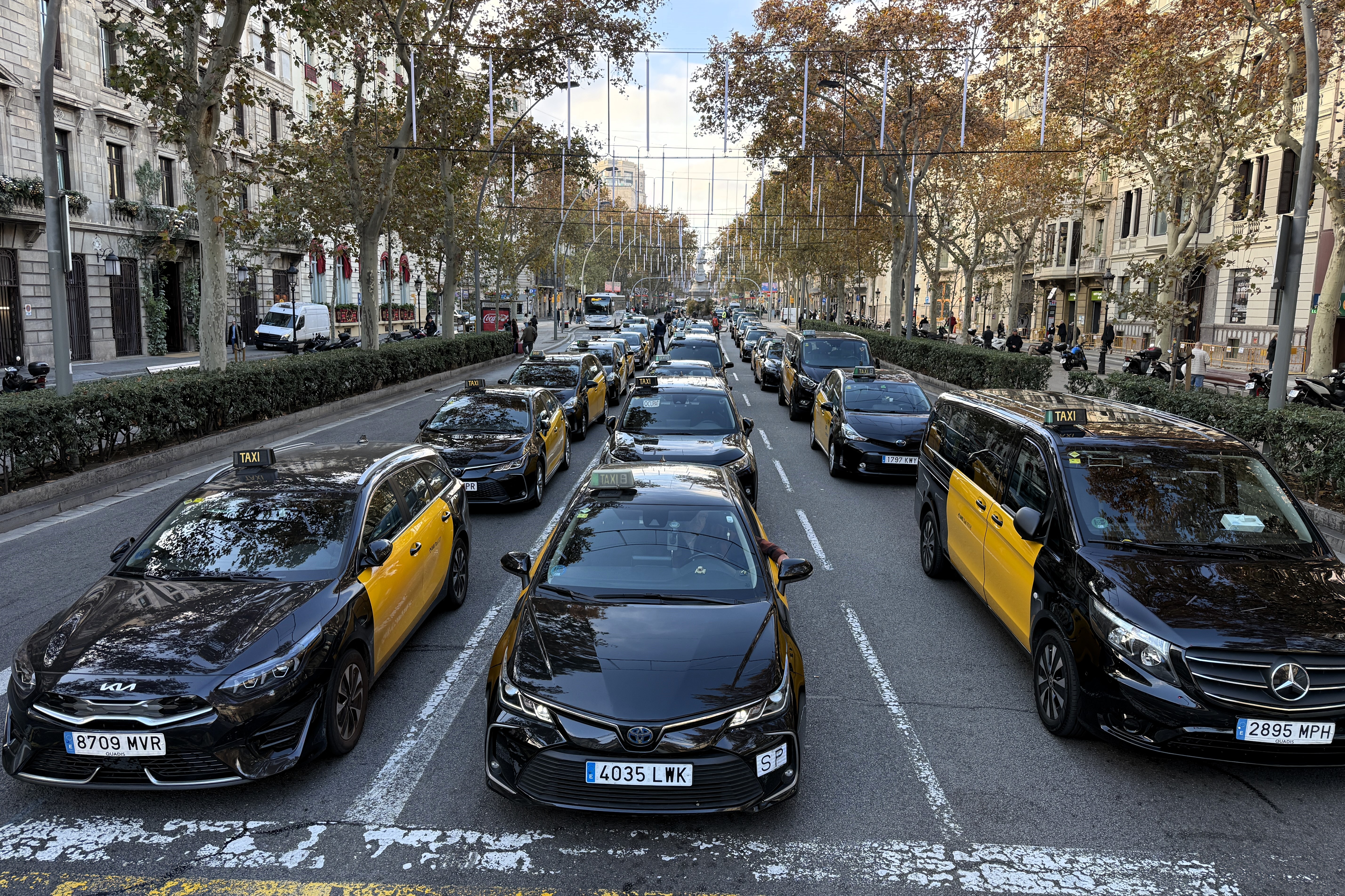 Dozens of taxis block Barcelona's Gran Via boulevard during a taxi strike on December 9, 2025