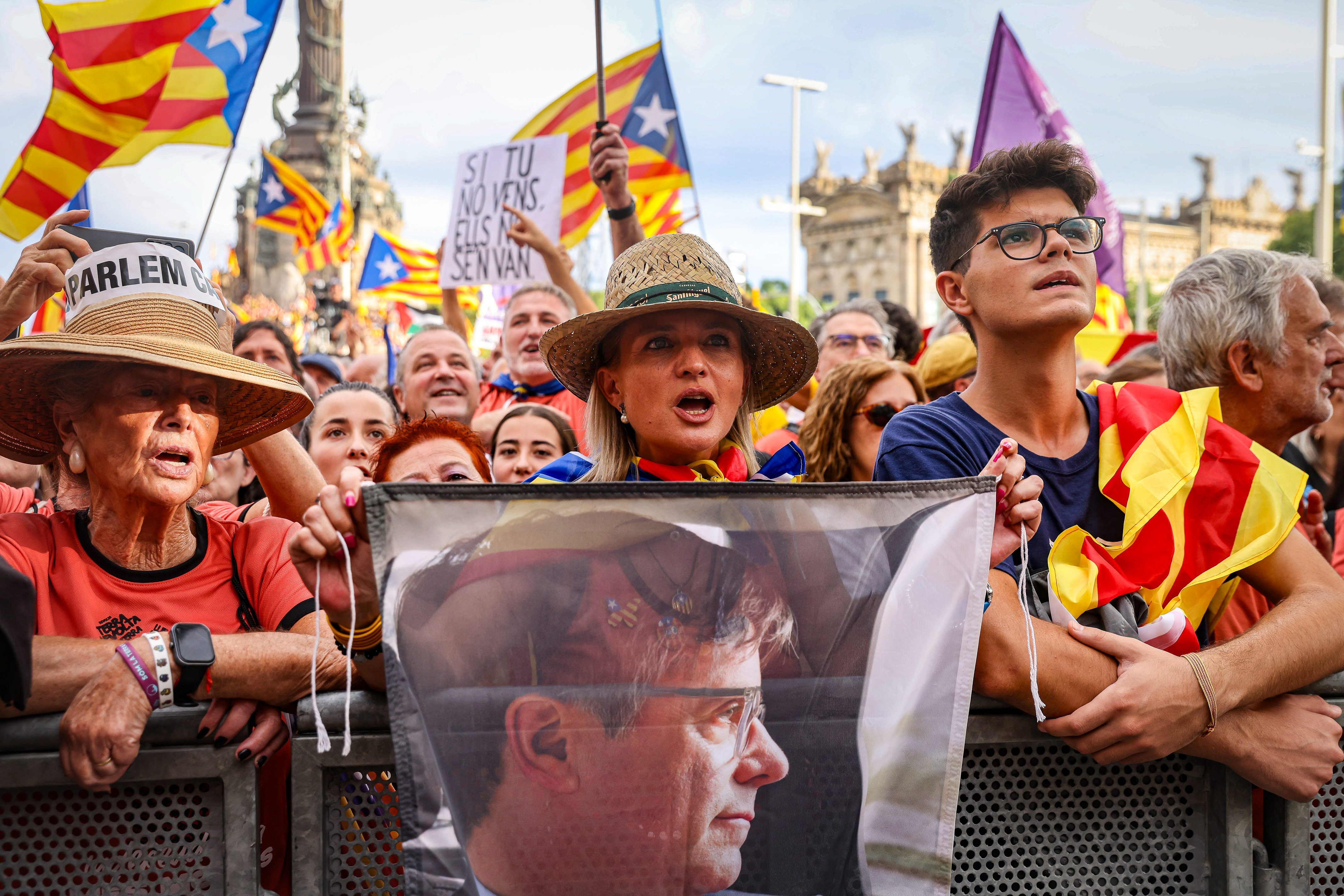 Protesters with an image of former Catalan president, Carles Puigdemont