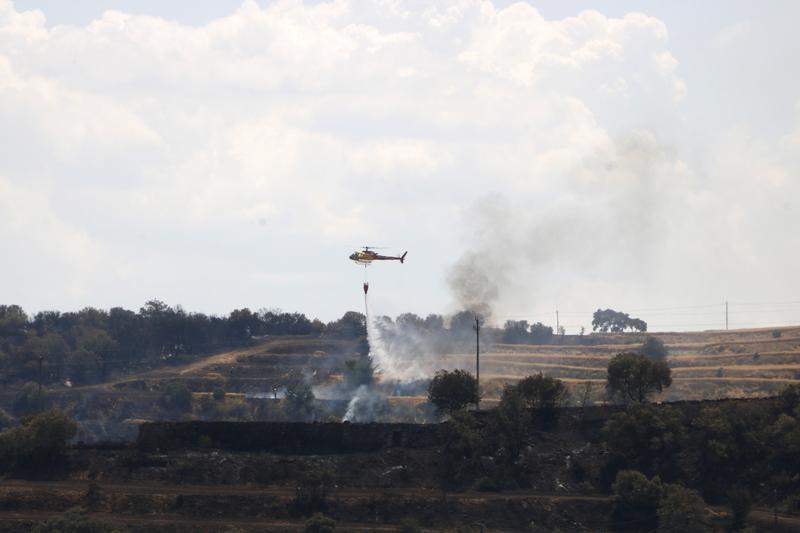 A helicopter flying over the Torrefeta i Florejacs fire on July 2, 2025s