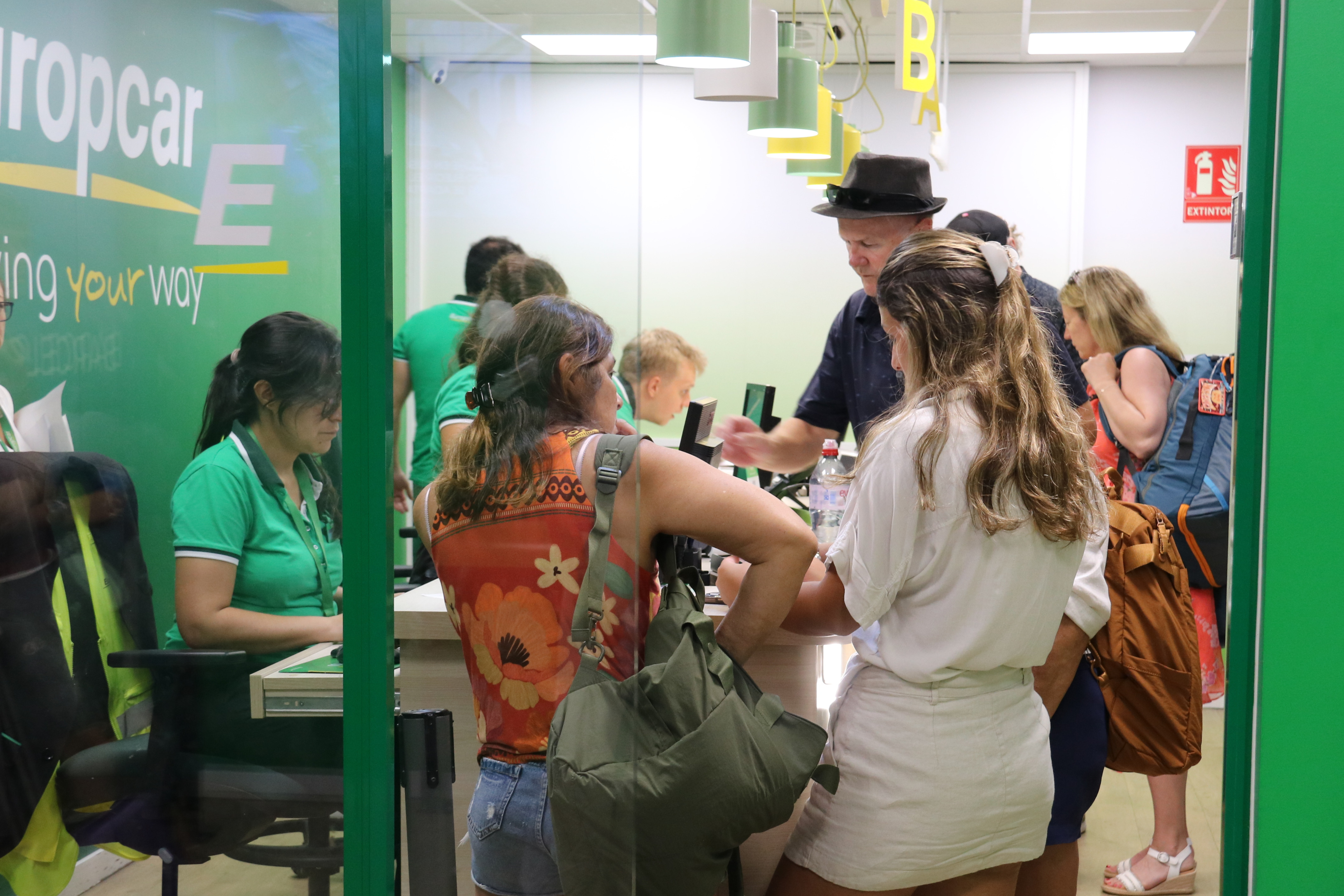 People looking to rent a car from Europcar at Sants train station car park in Barcelona