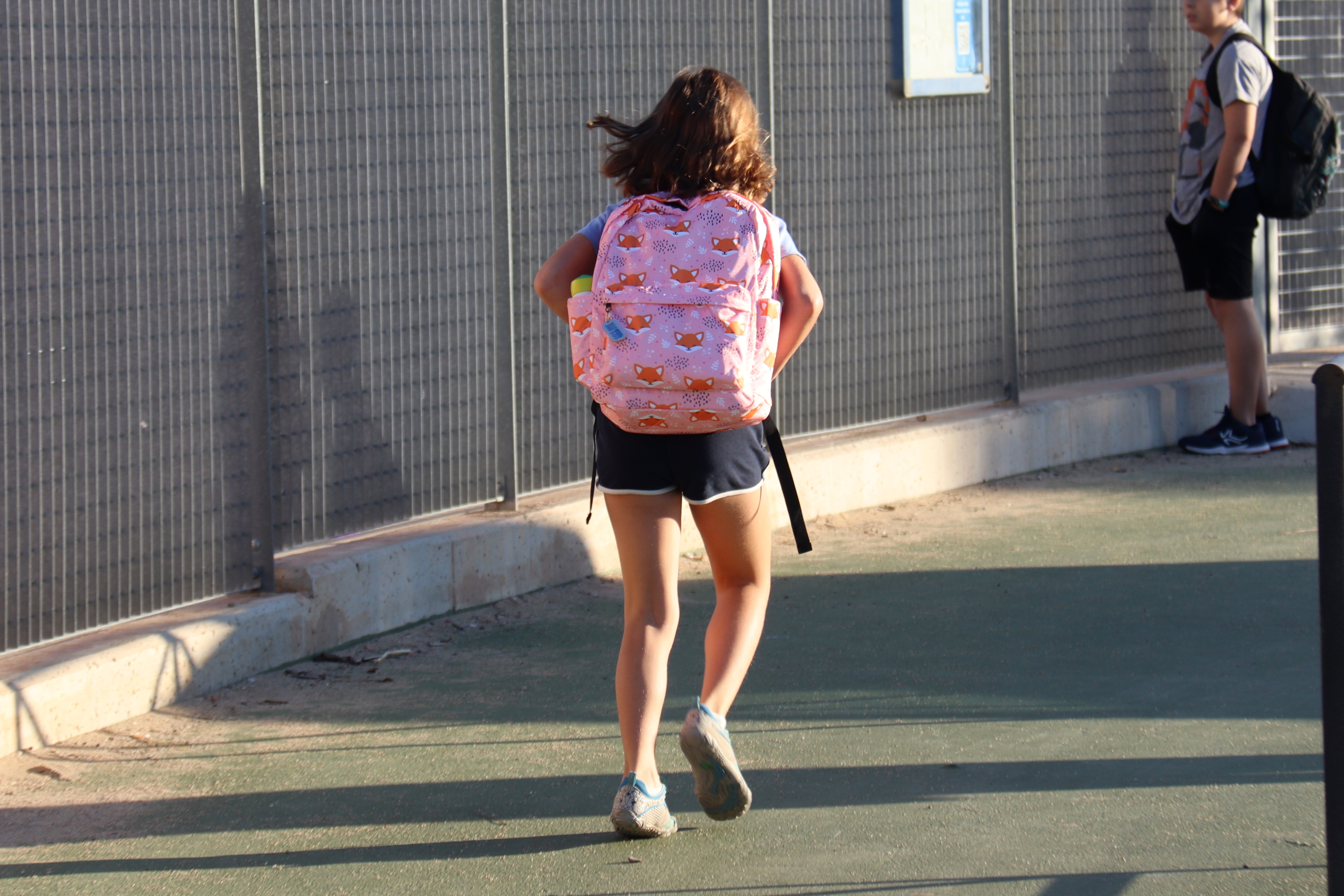 A student runs to school on the first day of classes in the La Vitxeta school in Reus, south of Catalonia