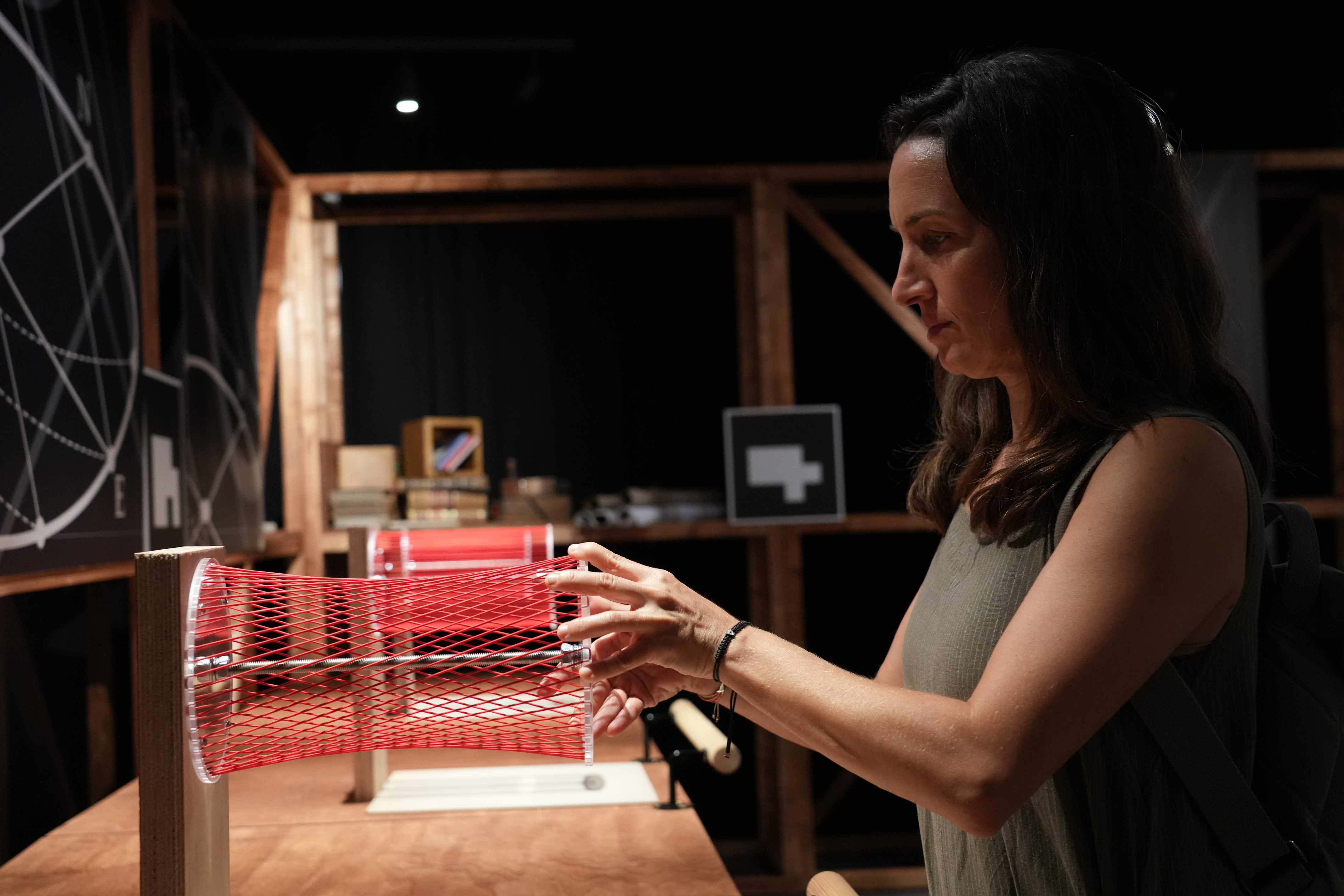 A woman uses one of Gaudí's unique inventions at the exhibition 'Gaudí Code: The Unprecedented Experience' at Espai Imagina.