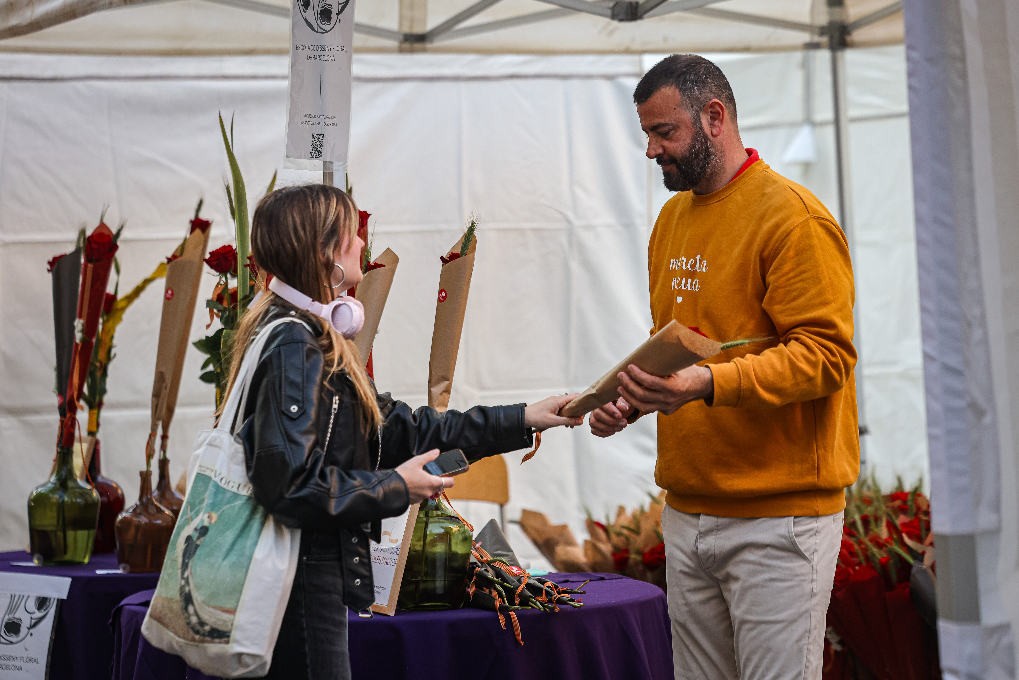 A girl buying a rose in Barcelona.