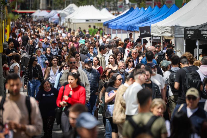 People stroll through the Sant Jordi book stalls in Barcelona