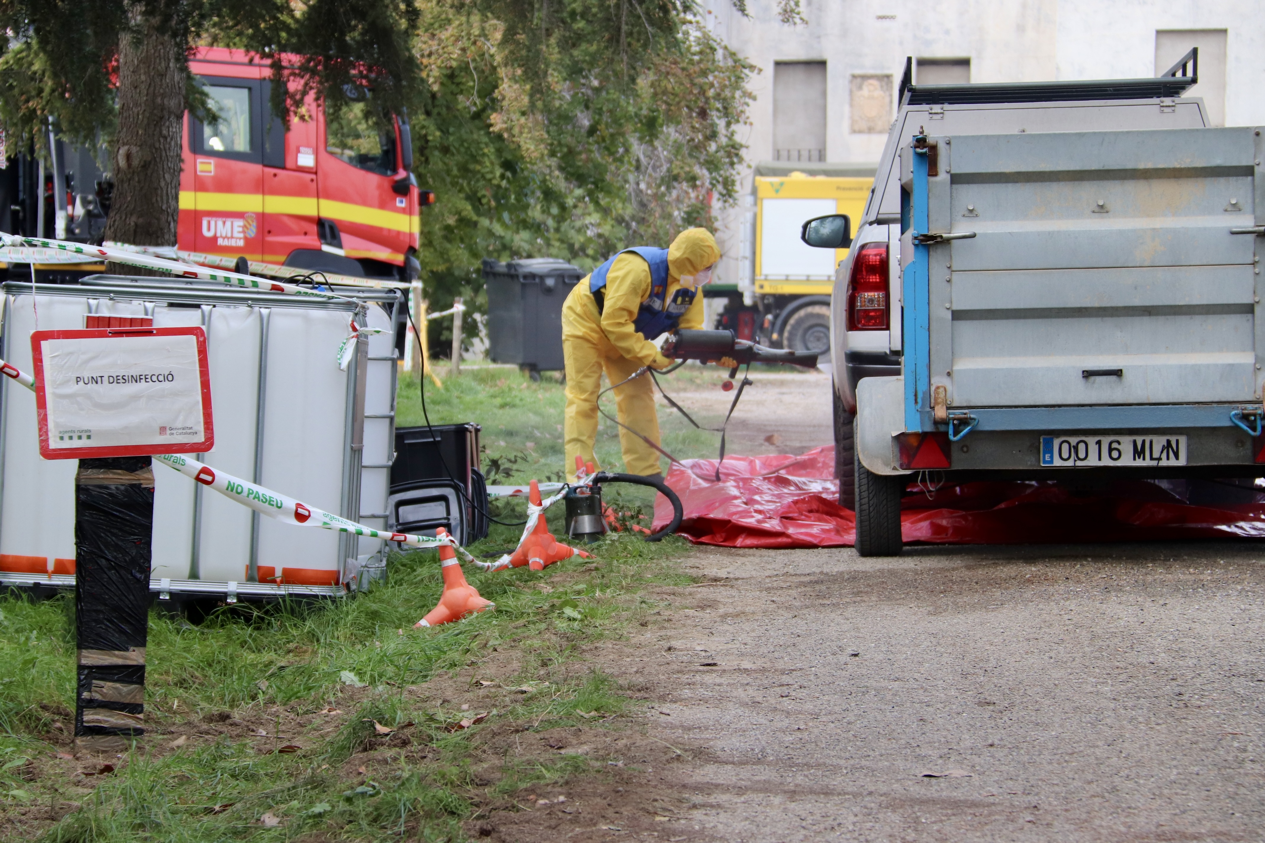 A member of the Military Emergency Unit (UME) disinfects a vehicle at the Advanced Command Centre in Torreferrussa