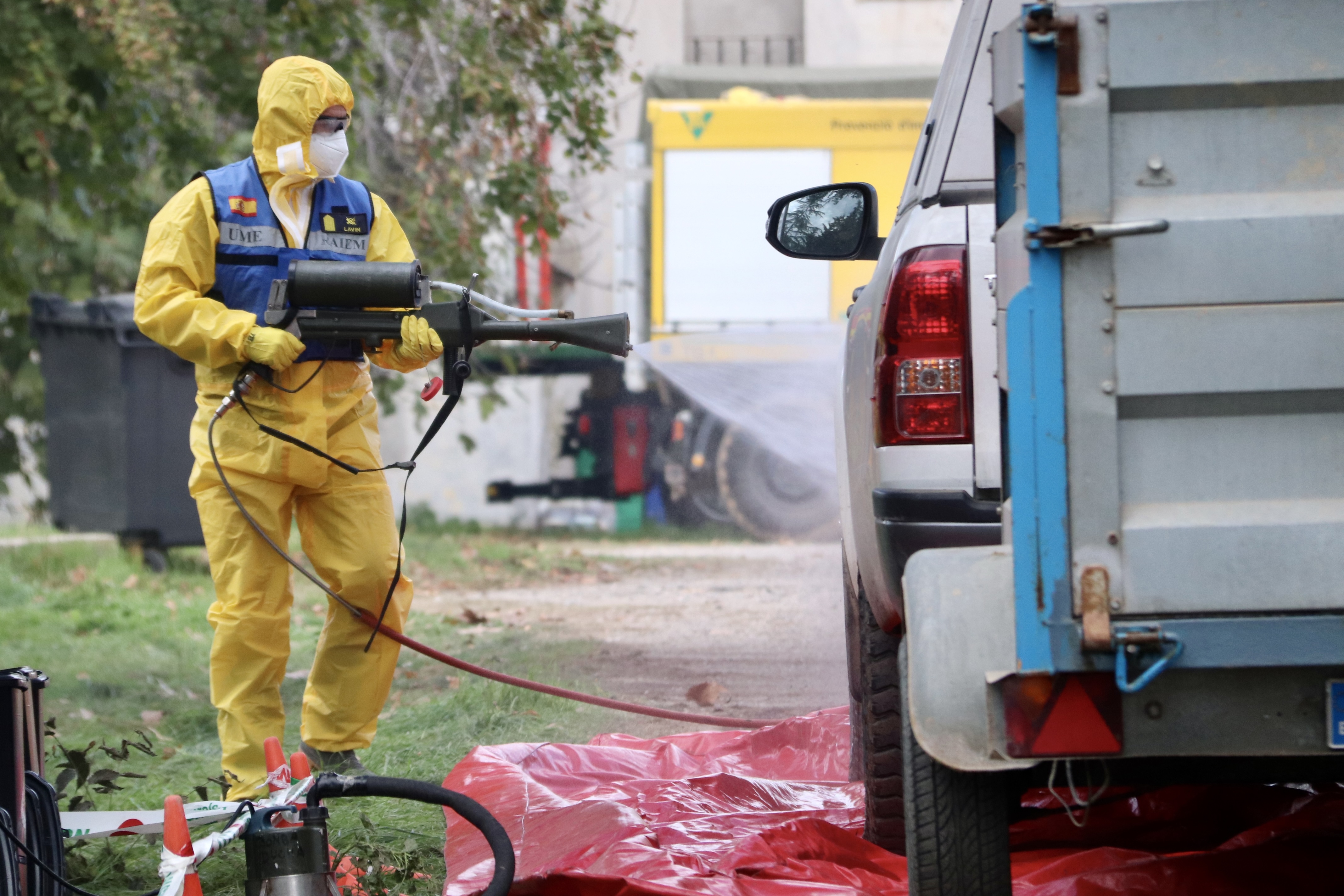 A member of the Military Emergency Unit (UME) disinfects a vehicle at the Advanced Command Centre in Torreferrussa