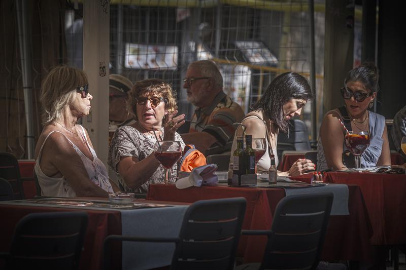 Several women enjoying a drink at a terrace in a restaurant in Barcelona