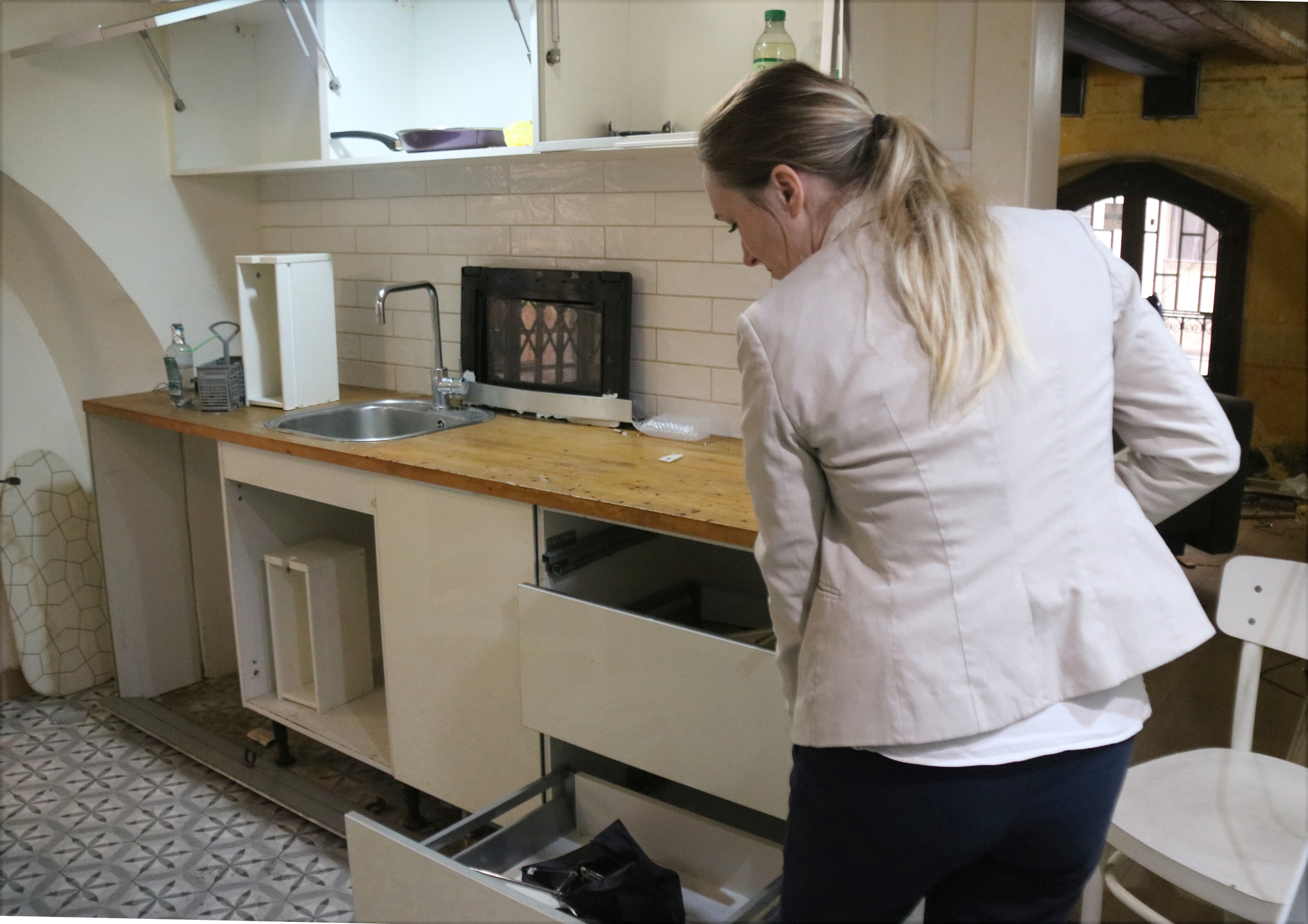 Rebecca Day of Ruby Realties inspects the damage after police dismantled the drug den