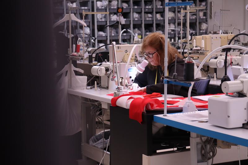 A worker sews a piece in a clothes factory