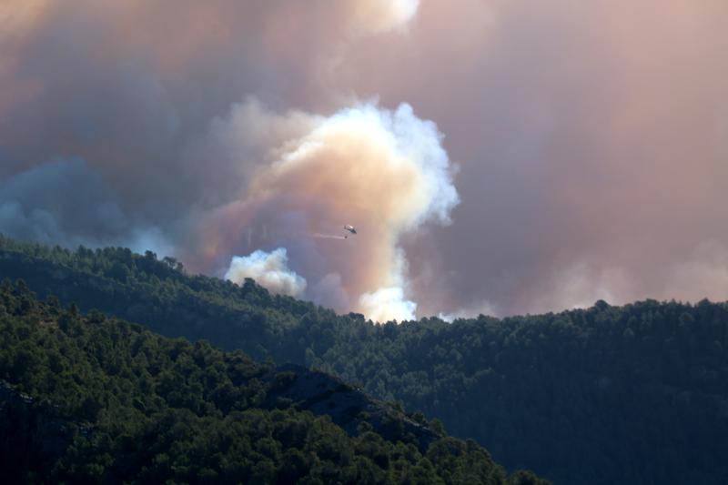 Helicopter drops water over the wildfire in Baix Ebre, southern Catalonia