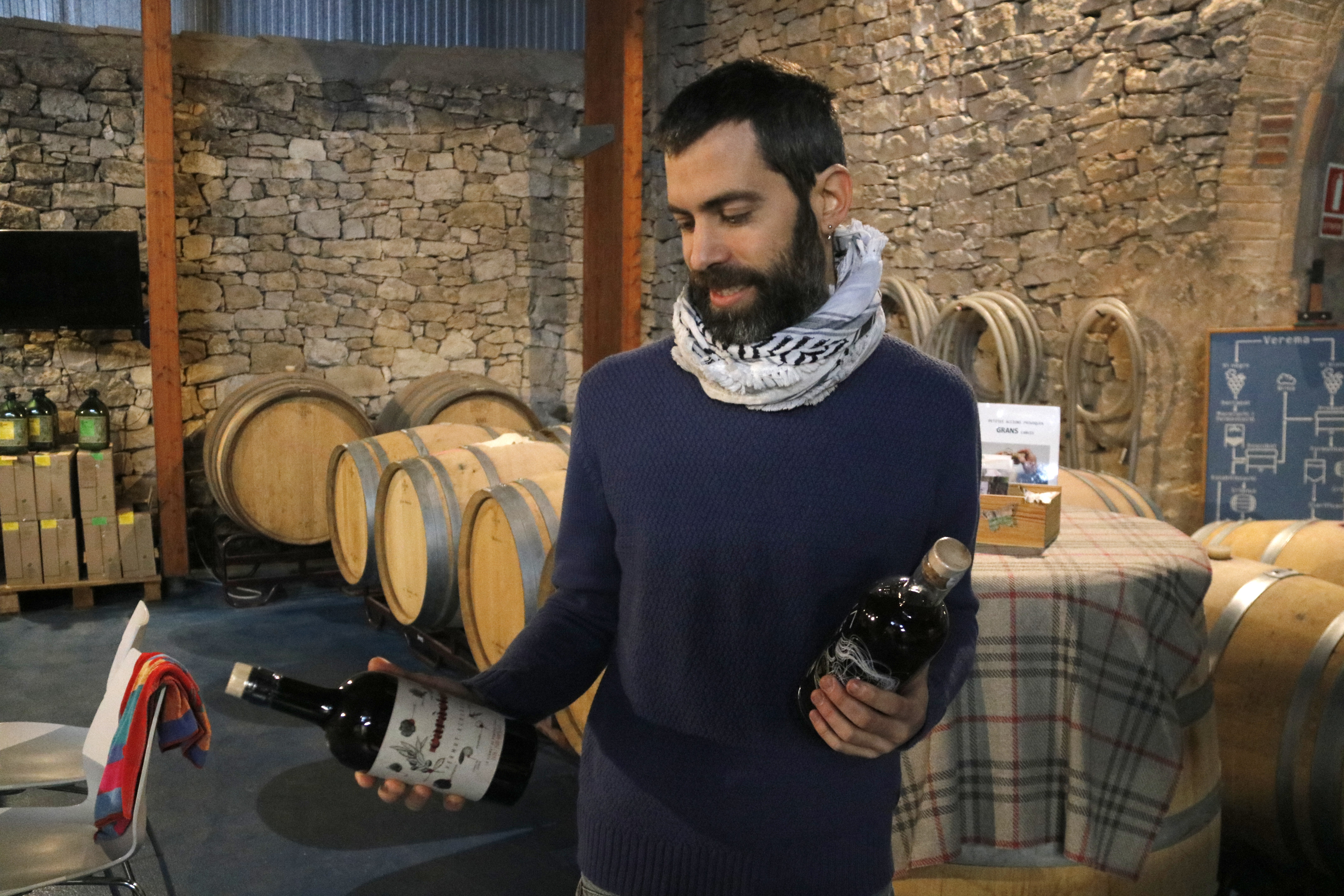 Andreu Culleré, of Tres Cadires, shows two bottles of vermouth and ratafia