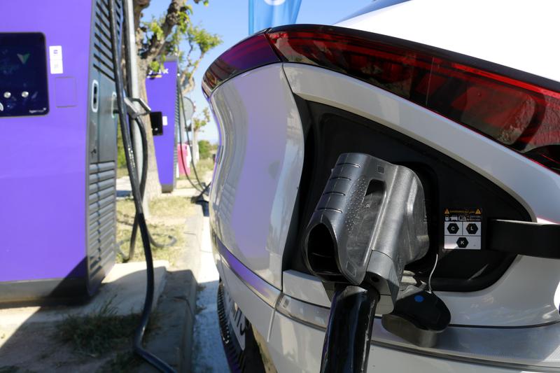 An electric vehicle charging at a public station