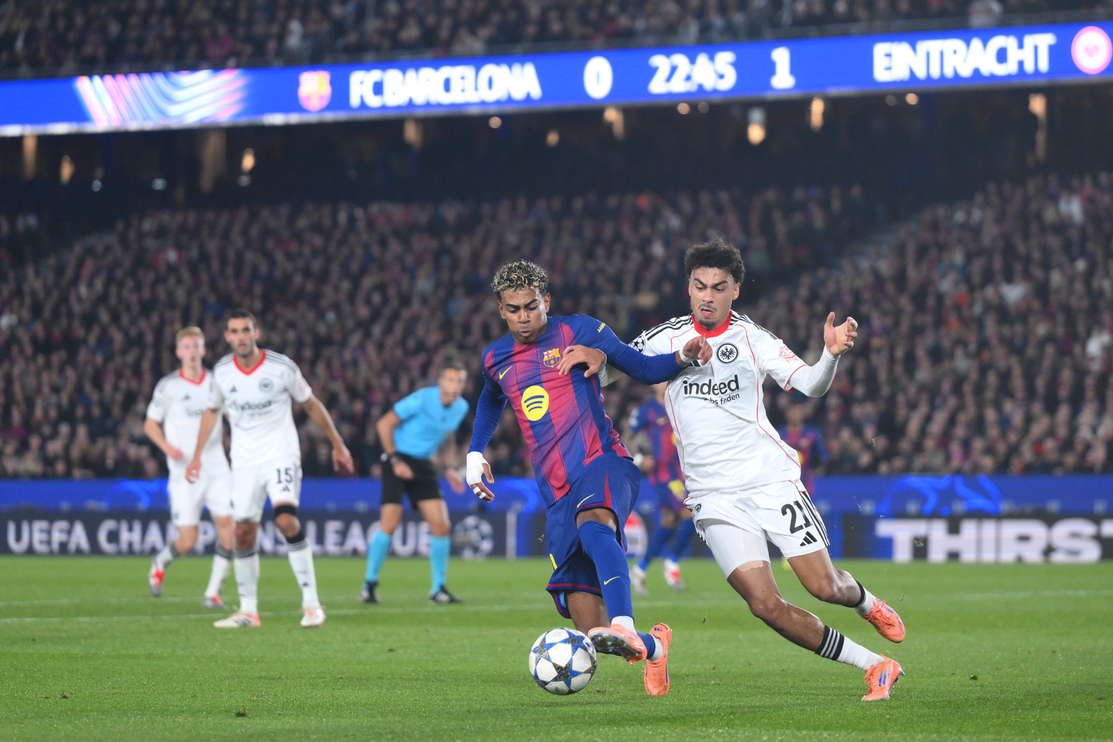 Lamine Yamal of FC Barcelona is challenged by Nathaniel Brown of Eintracht Frankfurt during the UEFA Champions League 2025/26 League Phase MD6 match between FC Barcelona and Eintracht Frankfurt at Camp Nou on December 09, 2025 in Barcelona, Spain