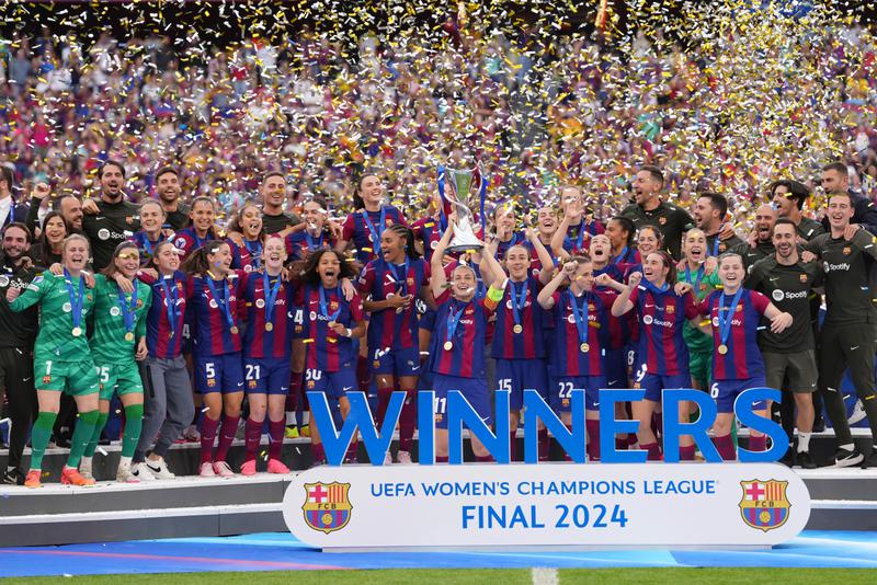 Alexia Putellas of FC Barcelona lifts the UEFA Women’s Champions League Trophy as her teammates celebrate after the team’s victory in the UEFA Women’s Champions League 2023/24 Final match at San Mames Stadium on May 25, 2024 in Bilbao, Spain.