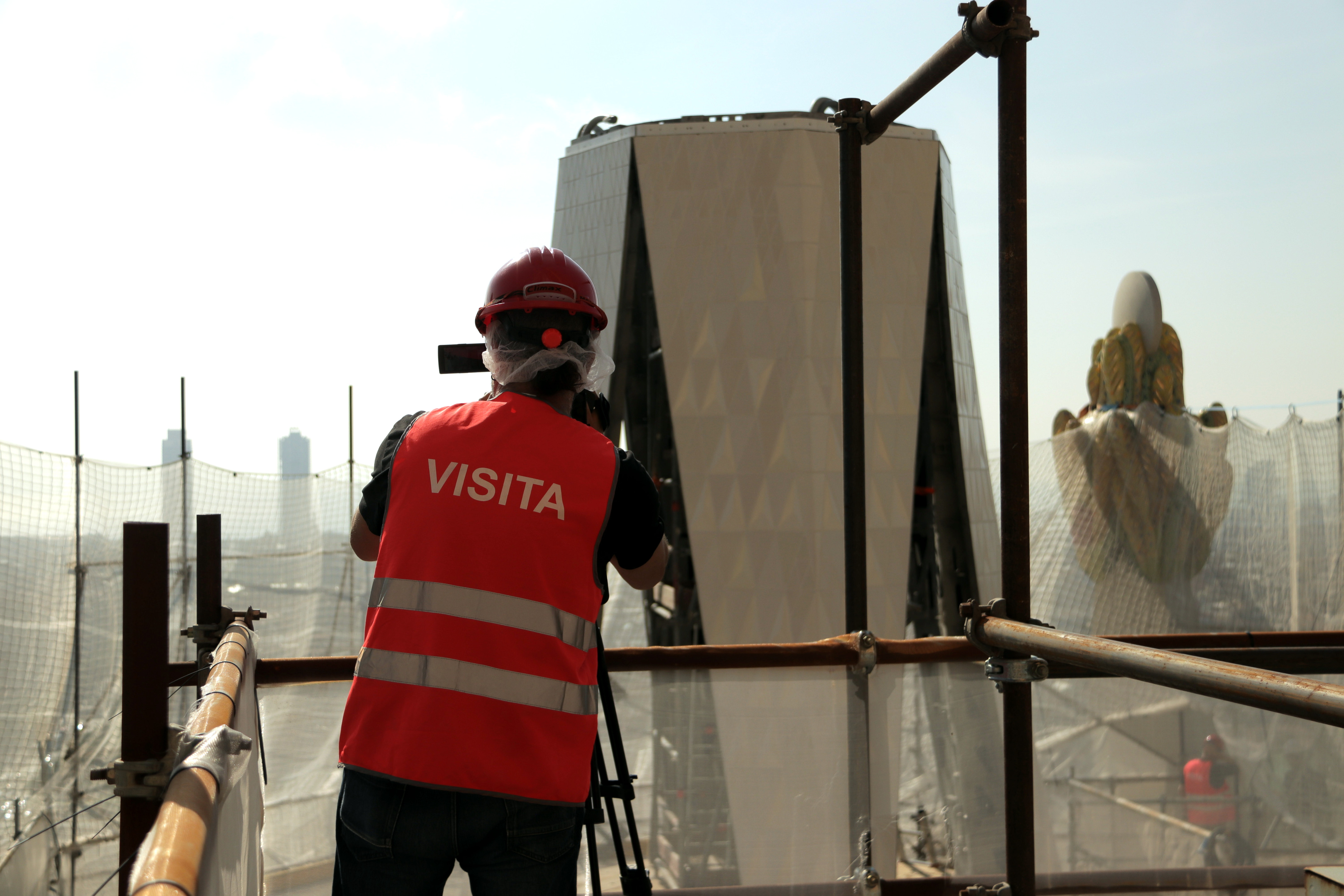 A person records part of the cross that will top Sagrada Família's Tower of Jesus Christ