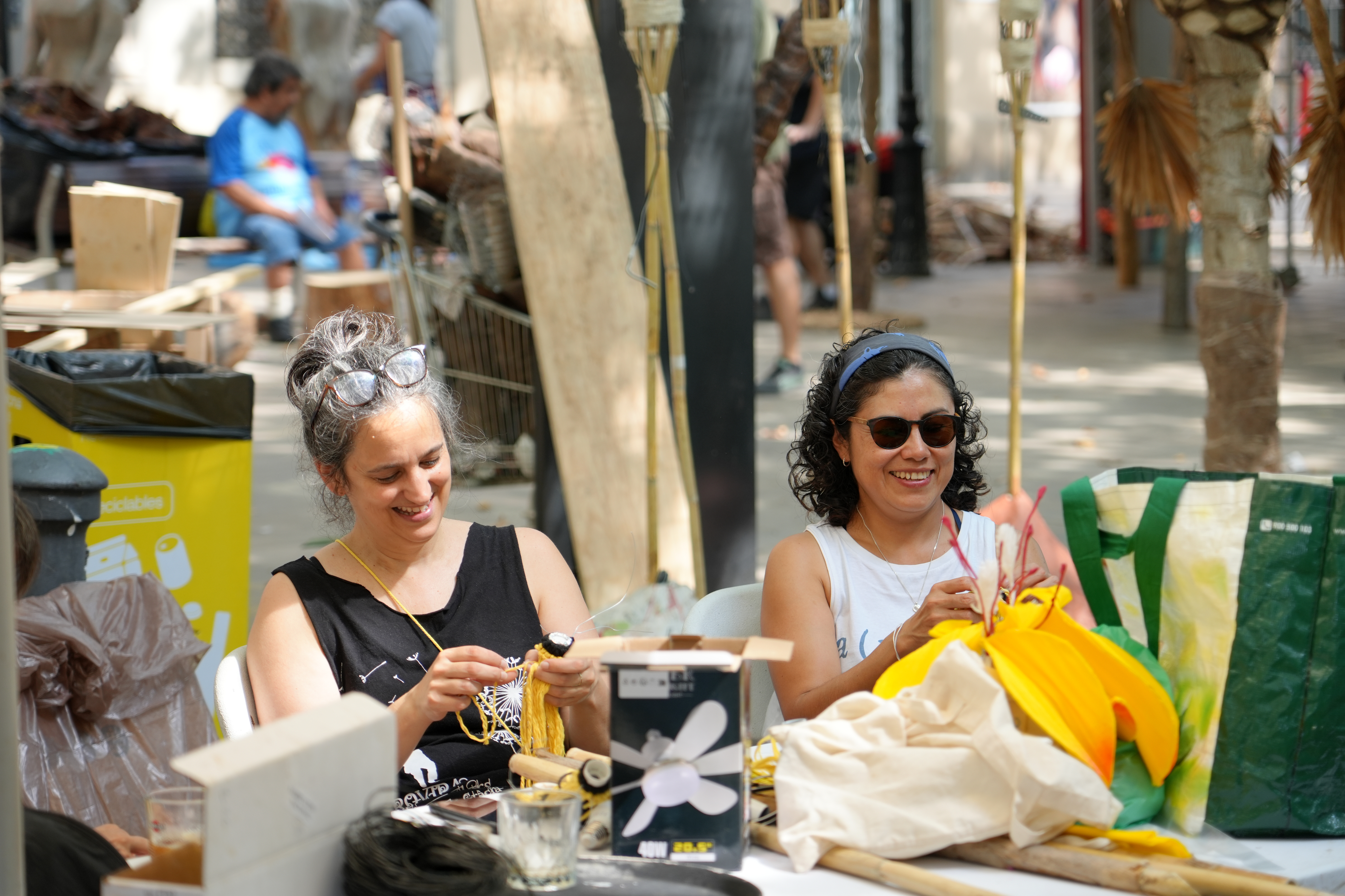 Two neighbours in Plaça Rovira i Trias preparing decorations for the 'Festes de Gràcia'
