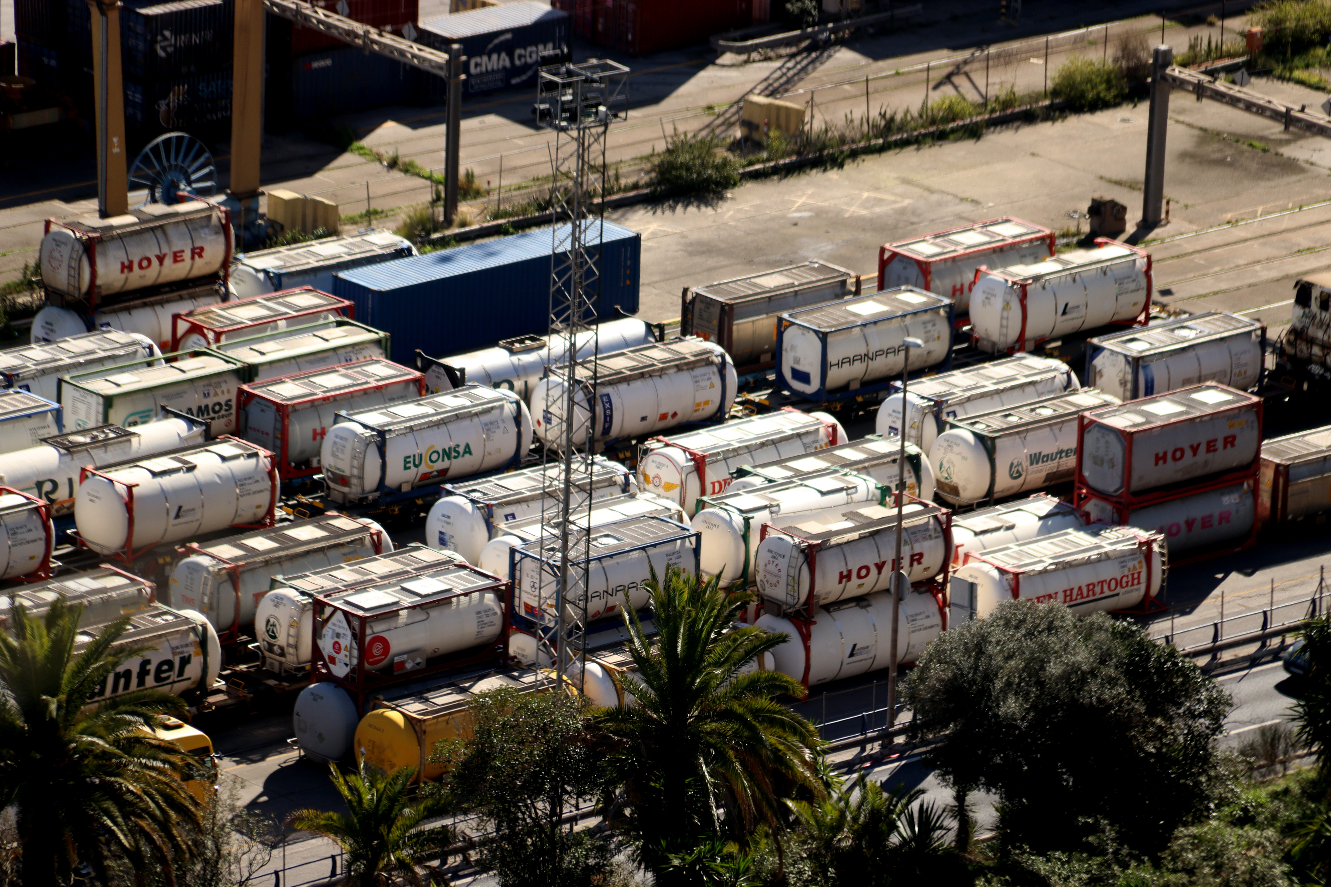 Tank containers loaded onto freight train wagons at the Port of Barcelona
