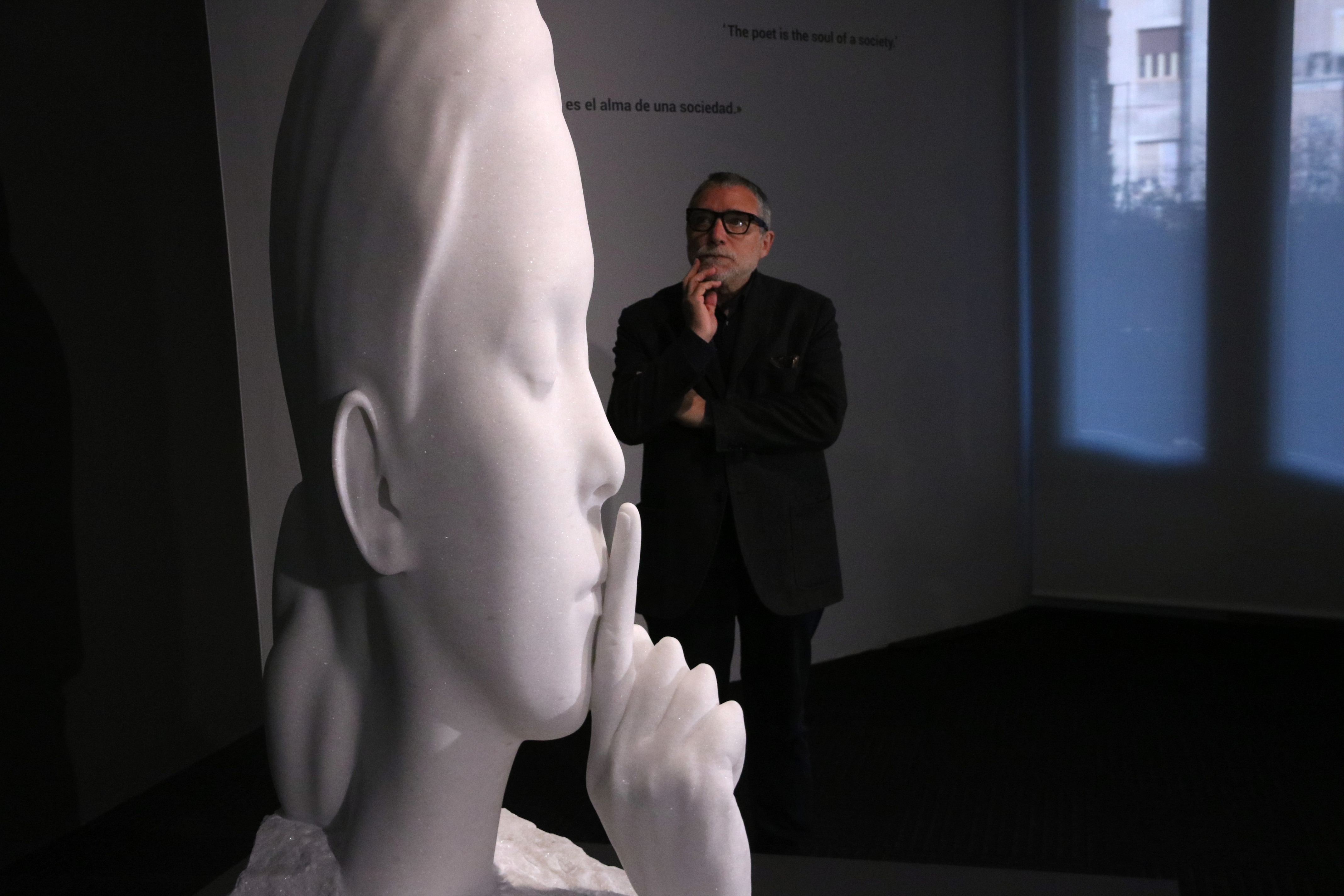 Sculptor Jaume Plensa observes one of his statues placed in 'La Pedrera' on March 30, 2023