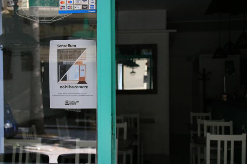 Poster of Barcelona Comerç association's campaign against increases in prices of energy in local establishments seen at 'Bo per tu Cafè' bar in Les Corts neighborhood on October 28, 2022