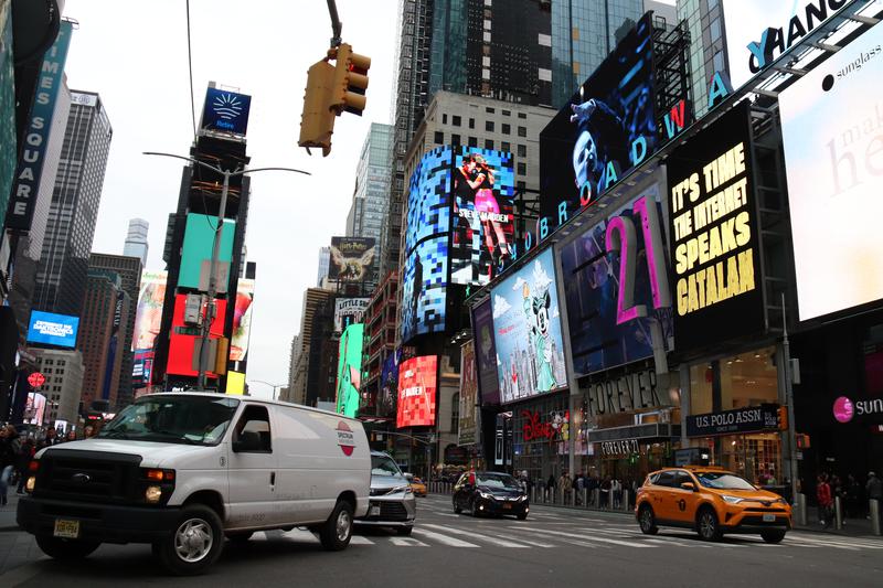 Times Square billboards in New York with a message advertising Project AINA in April 2022