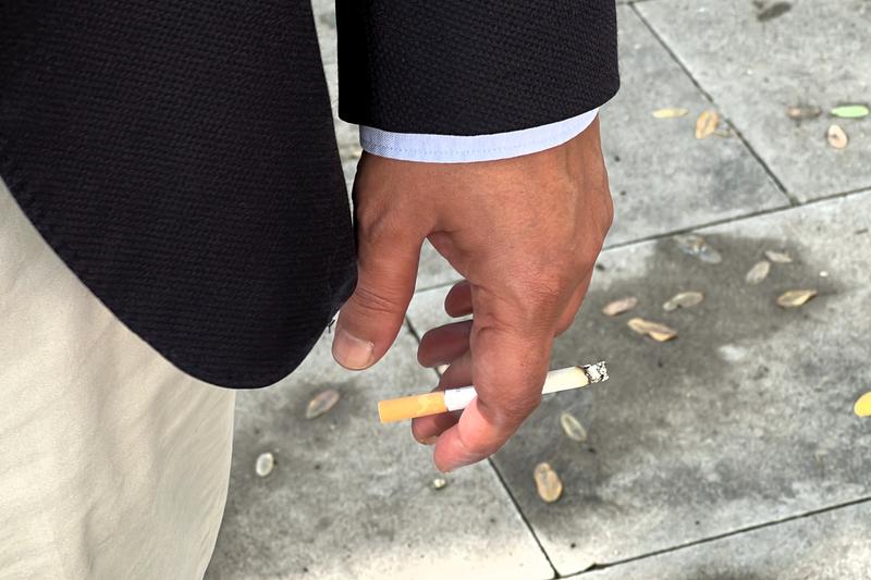 Close-up of a cigarette in a man's hand