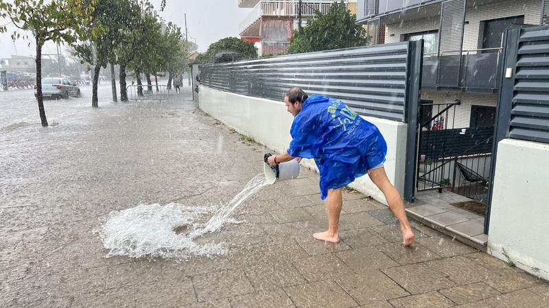 A resident removes water from his home in Castelldefels.