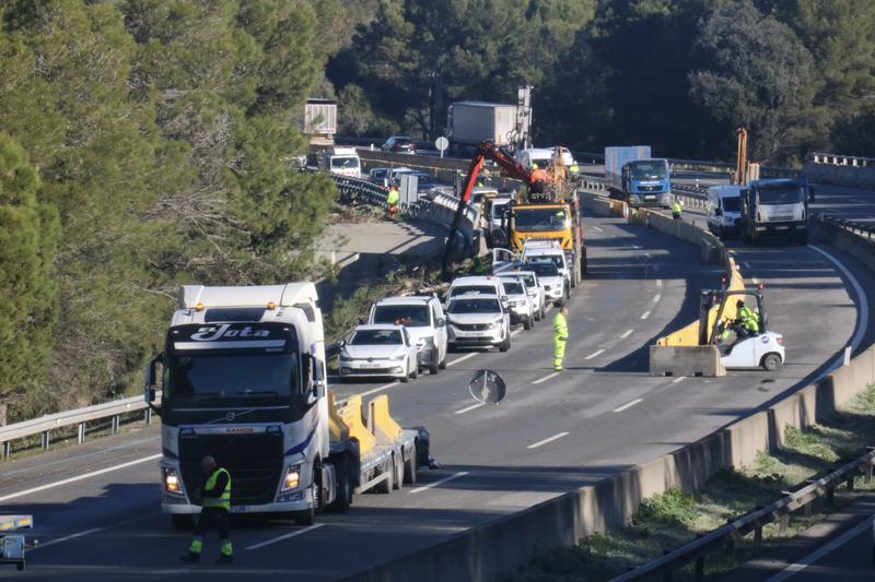 Workers installing concrete barriers on the AP-7 near the site of the Gelida rail accident