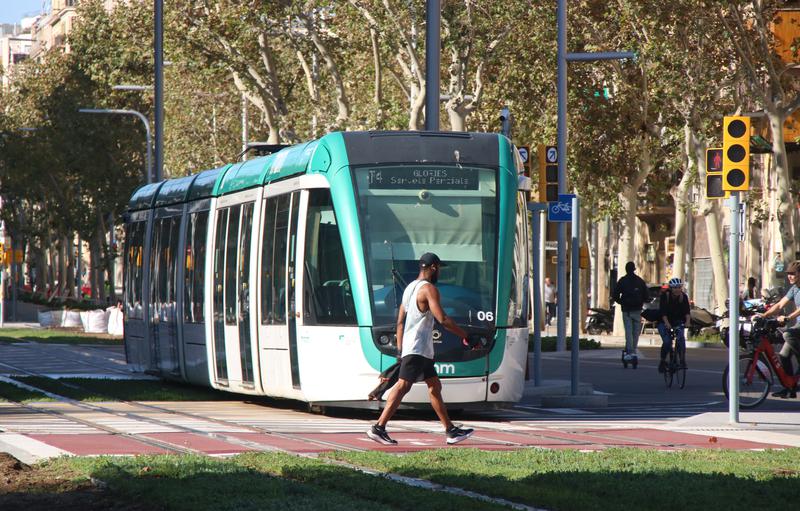 A person crosses Diagonal Avenue in front of the tramway connecting Glòries square and Verdaguer station during testing in an archive picture