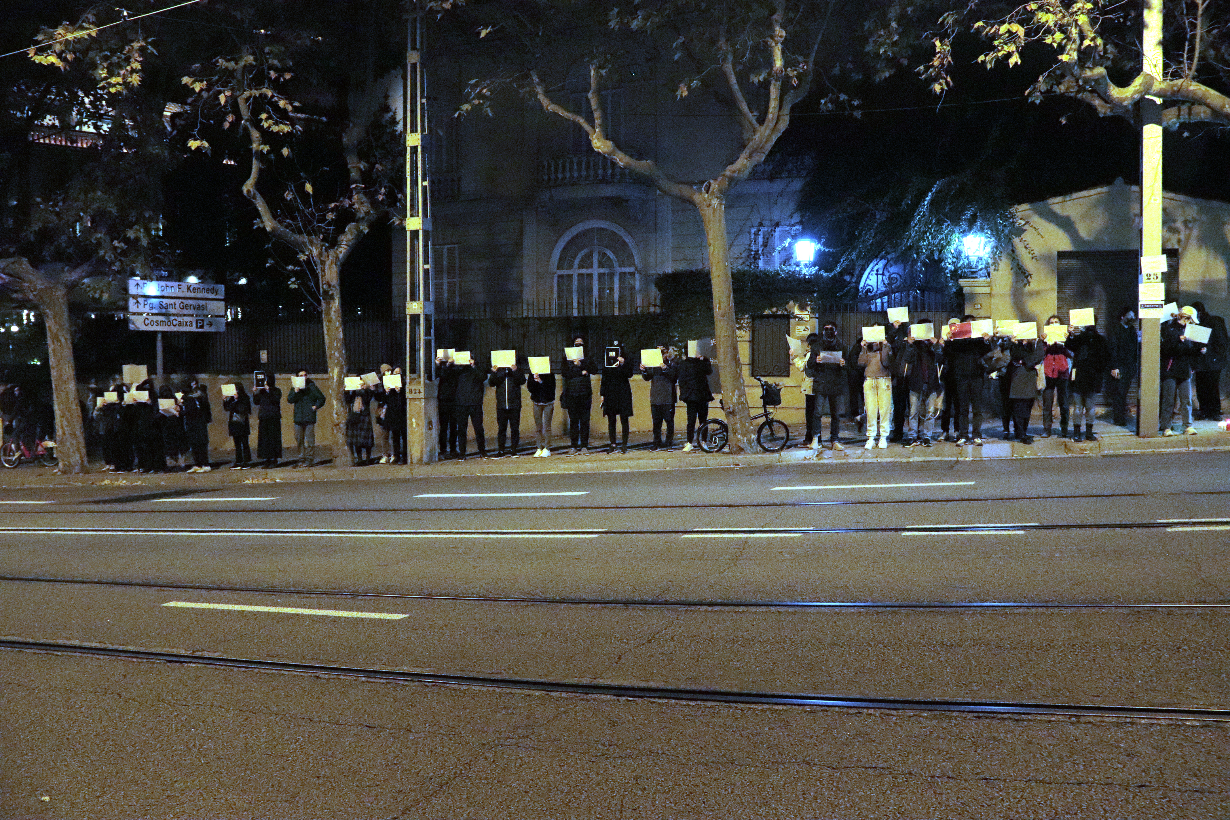 Dozens show blank sheets of paper outside China's consulate in Barcelona, in Avinguda Tibidabo