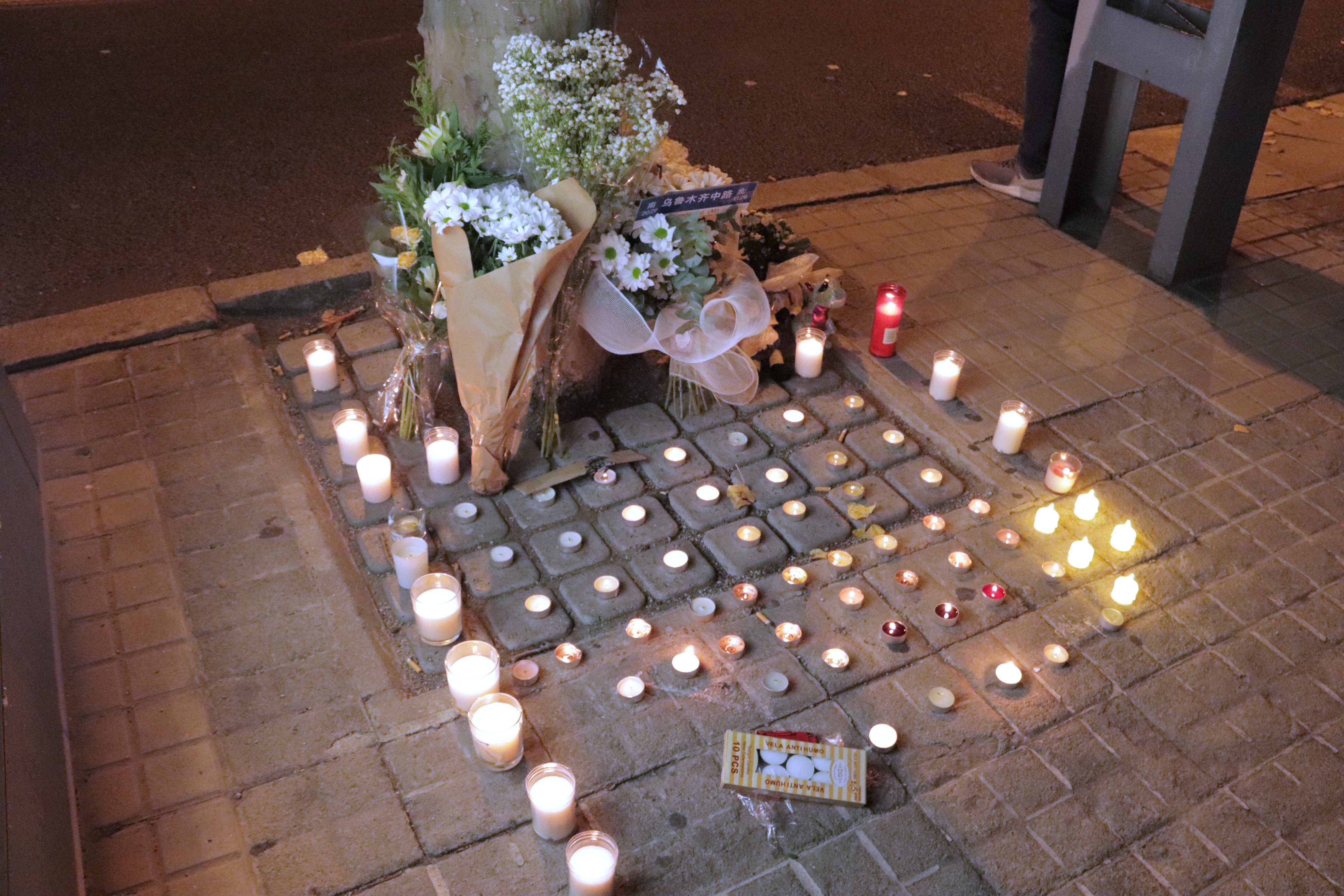 Some candles were lit up as a tribute to the victims in Urumqi fire