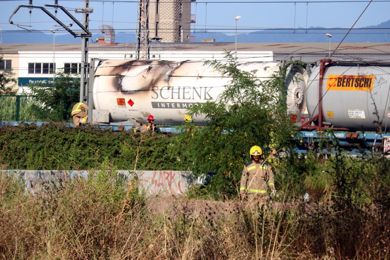 Firefighters beside a burned train carrying liquified gas near Girona on July 25, 2024