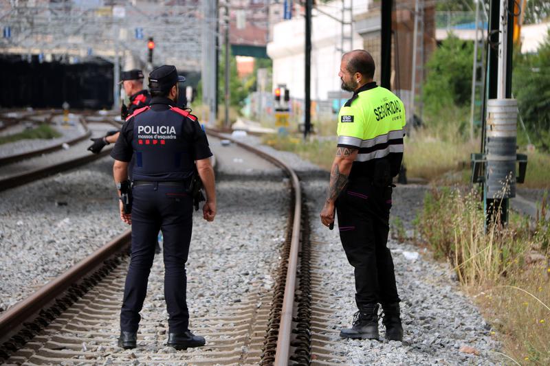 Catalan police Mossos d'Esquadra overlooking a the repairs in Sant Andreu Comtal