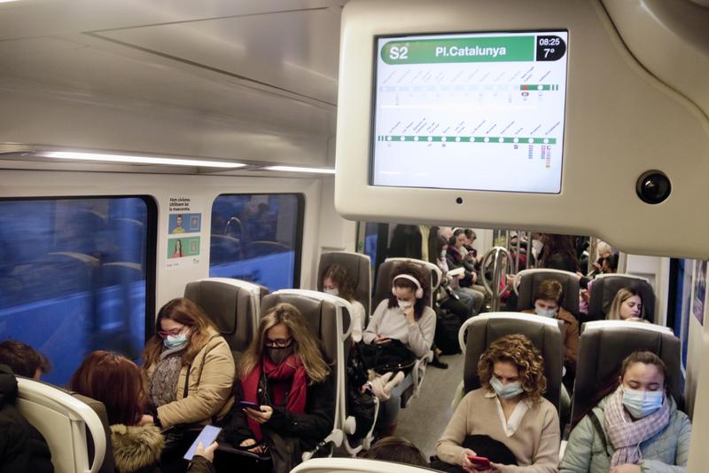A FGC train with passengers wearing face masks in December 2022