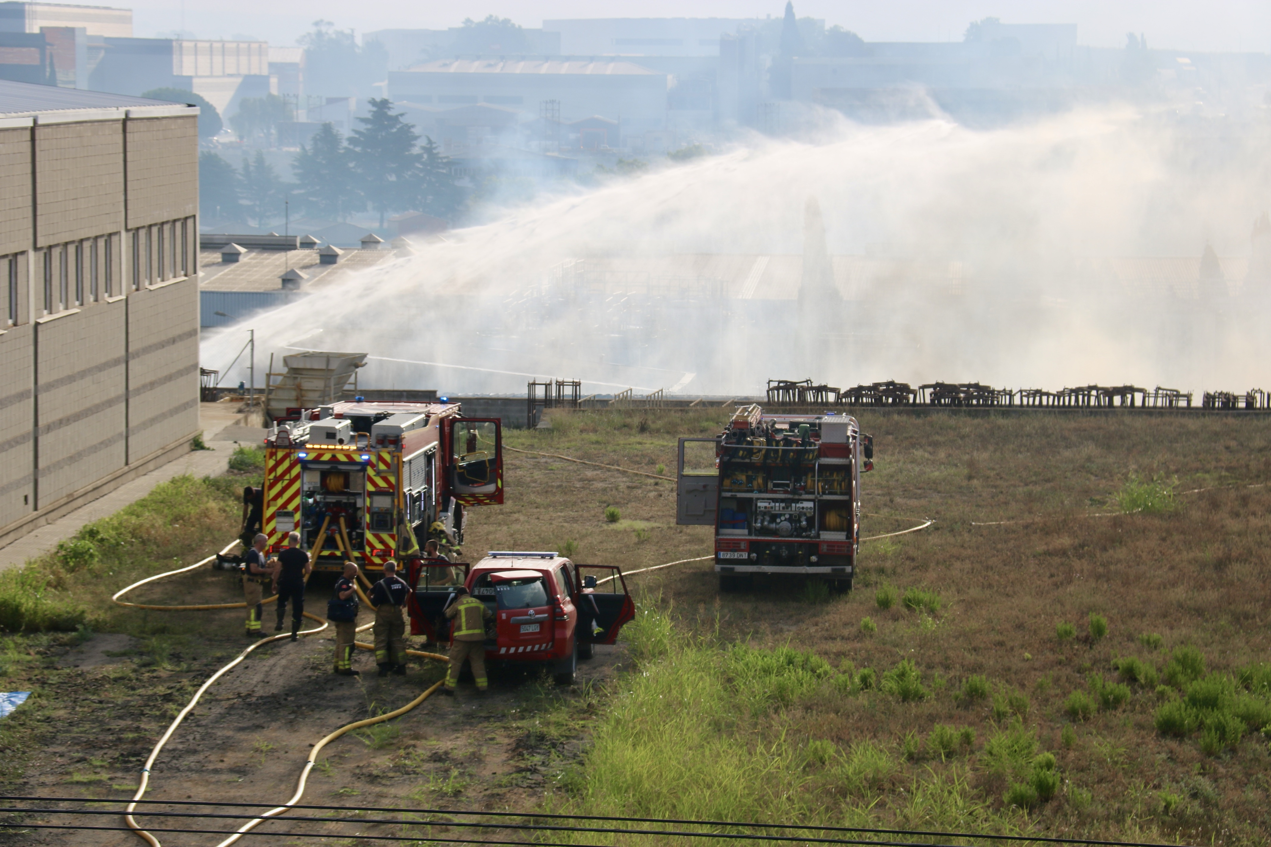 Firefighters work to extinguish a fire in the Barnastock company near Polinyà, just outside of Barcelona, on July 19, 2024