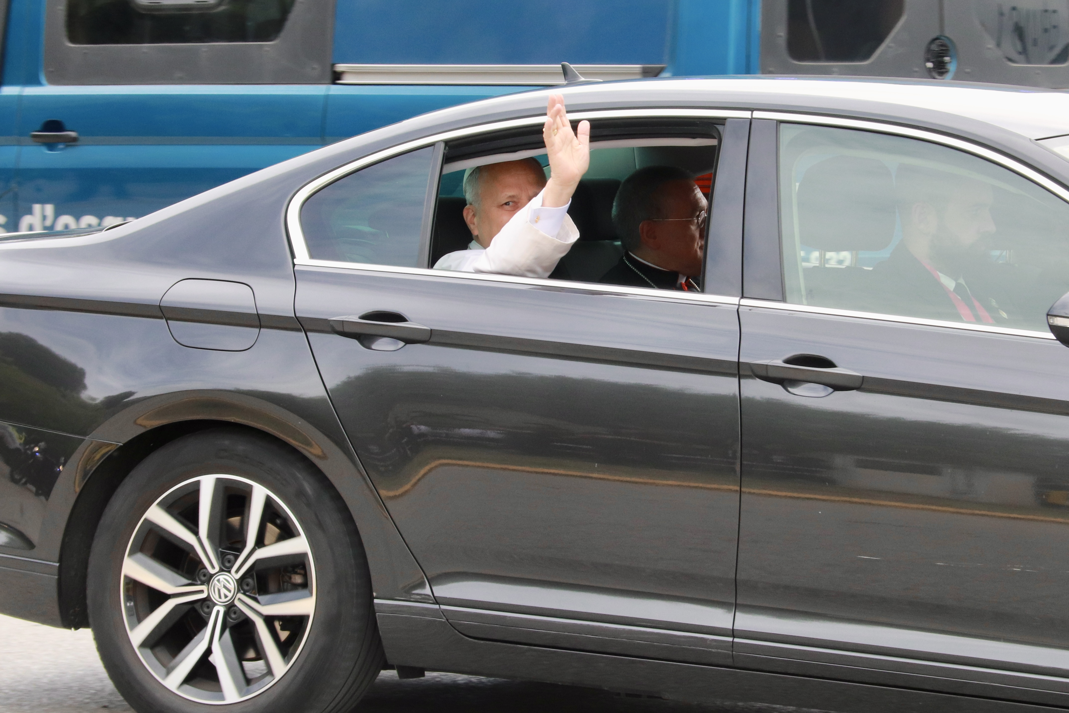 Pope Leo XIV waves to journalists on his arrival at Brians 1 prison