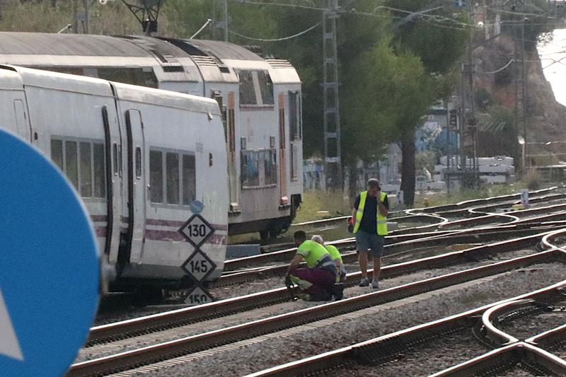 Workers inspect rails after Rodalies train derailed near Vilanova i la Geltrú on September 15, 2023