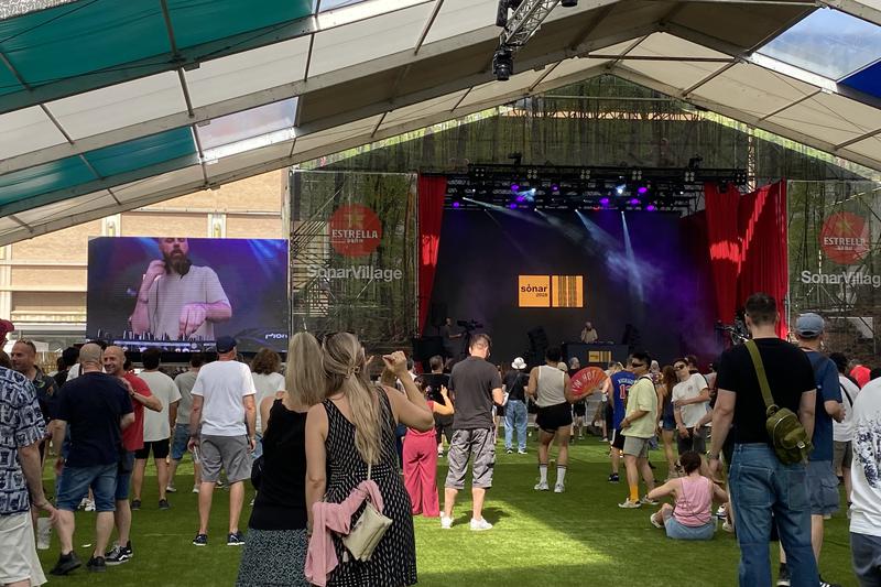 A crowd of people enjoying a DJ set at SonarVillage during the Sónar Festival