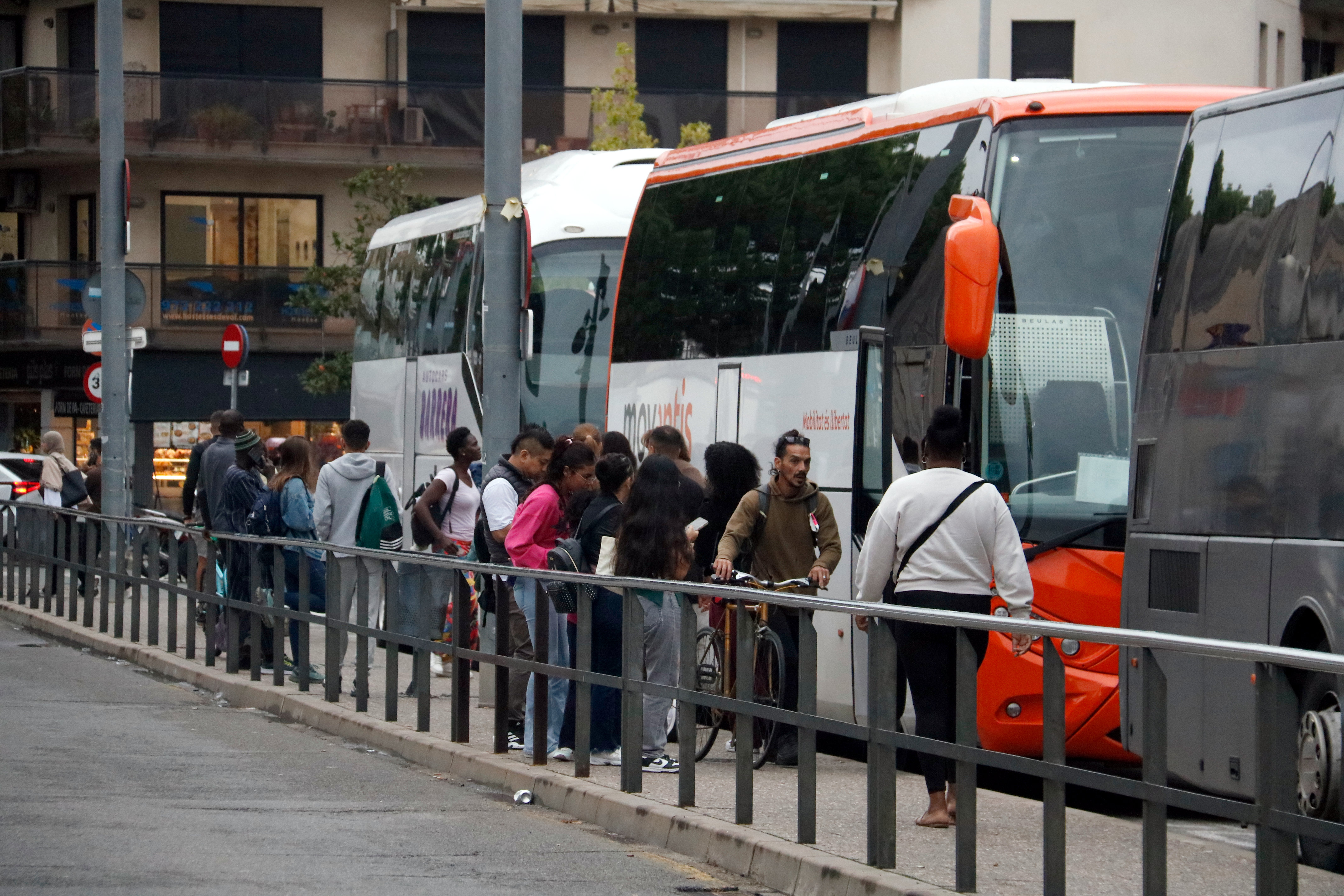Train passengers queue for replacement bus services in Girona