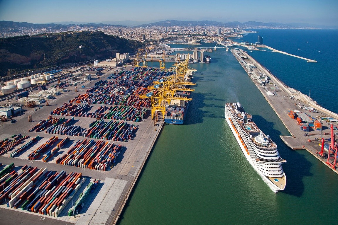 An aerial image of the Barcelona port with a cruise and the Catalan capital visible at the back